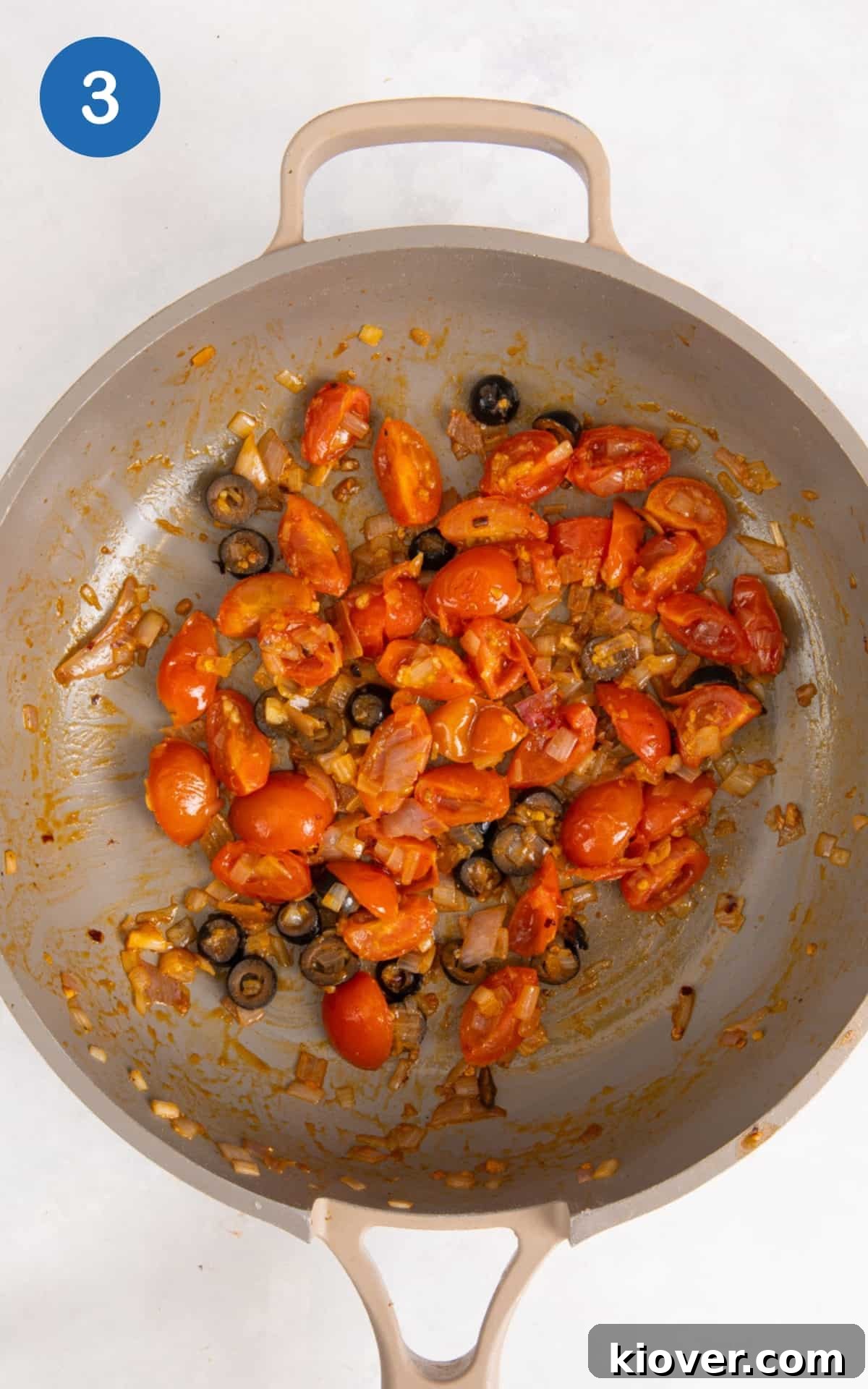 tomatoes, olive and onion frying in a pan.