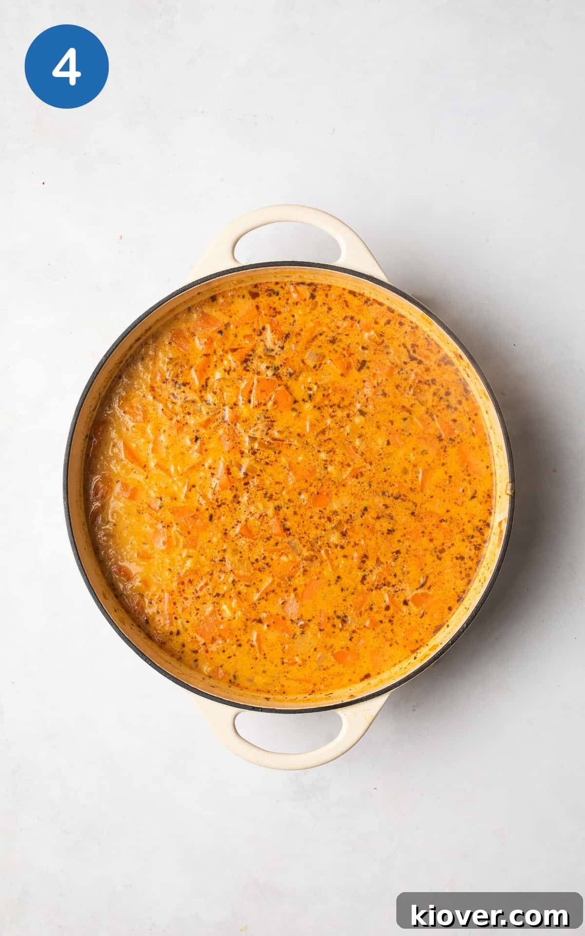 Hearty Carrot and Red Lentil Soup with Warm Spices 7 adding coconut milk and vegetable stock to the pot.