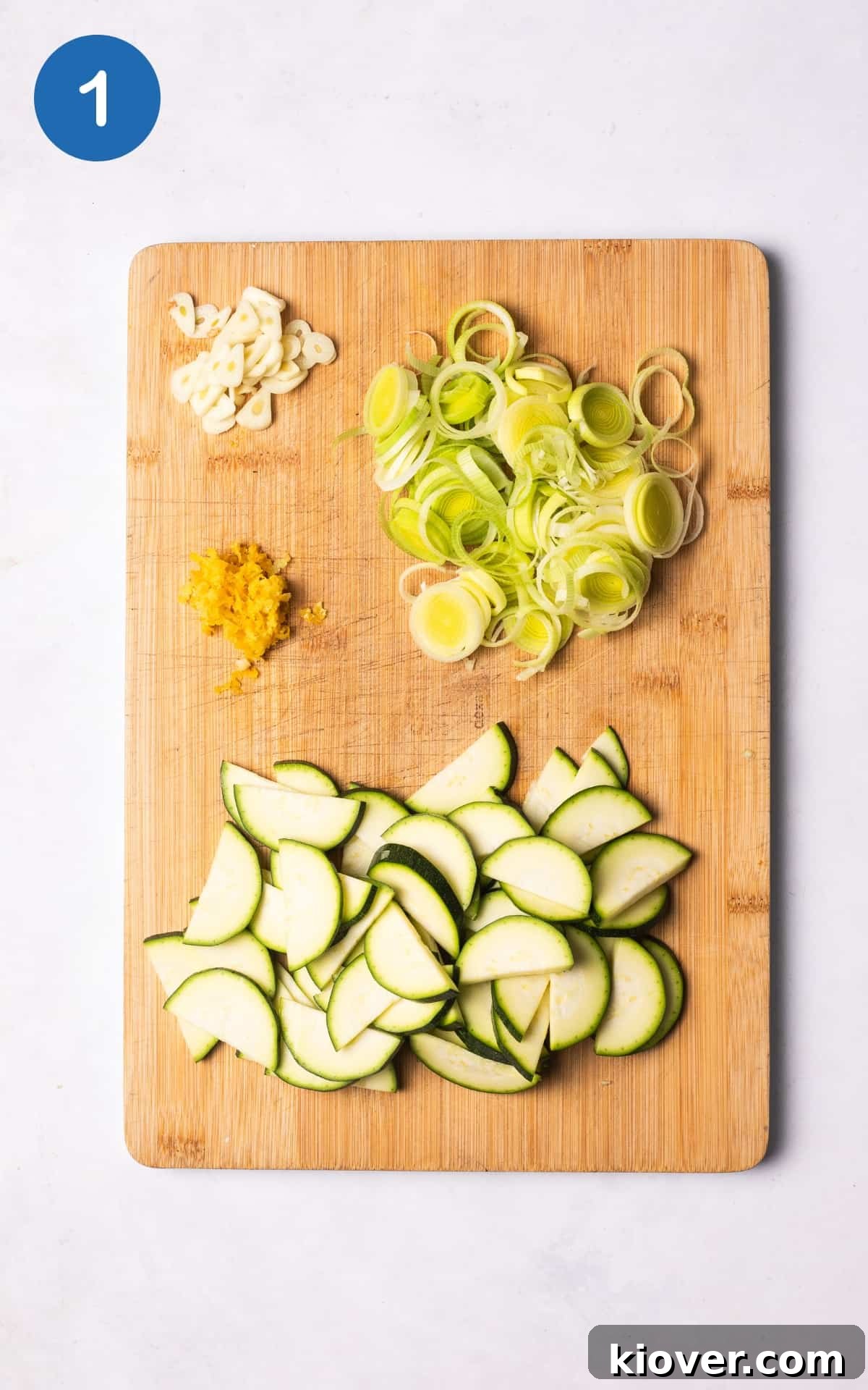 Zucchini Pasta Recipes: Quick Weeknight Meals with Fresh Sauce 4 leek, garlic, lemon and courgette on a wooden cutting board.