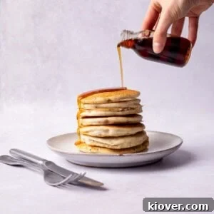 43 Gluten-Free Vegan Recipes for Everyday Meals and Desserts 3 Pouring Maple syrup over gluten free pancakes.