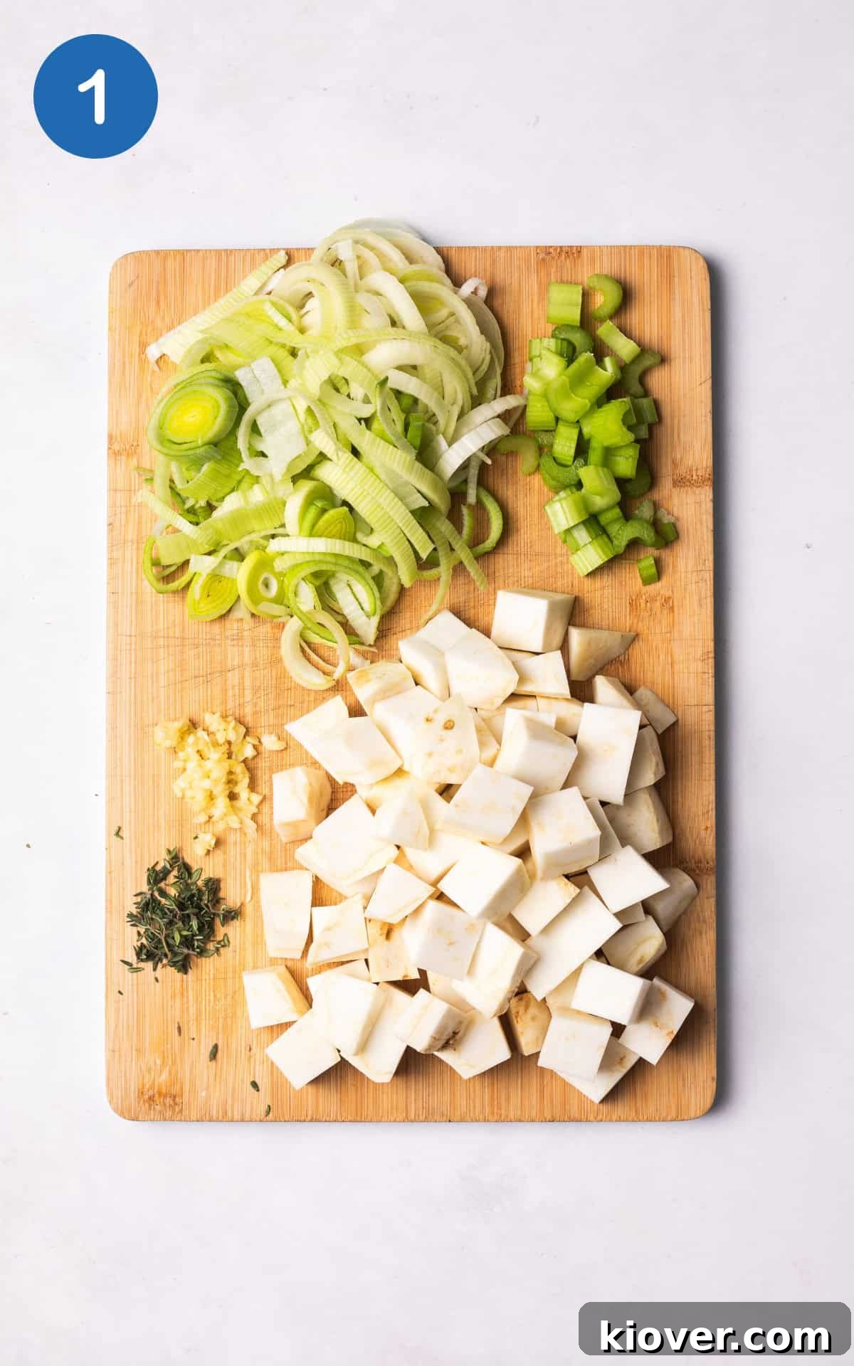 Creamy Celeriac Soup Recipe with Garlic and Thyme 4 fresh vegetables on a cutting board.