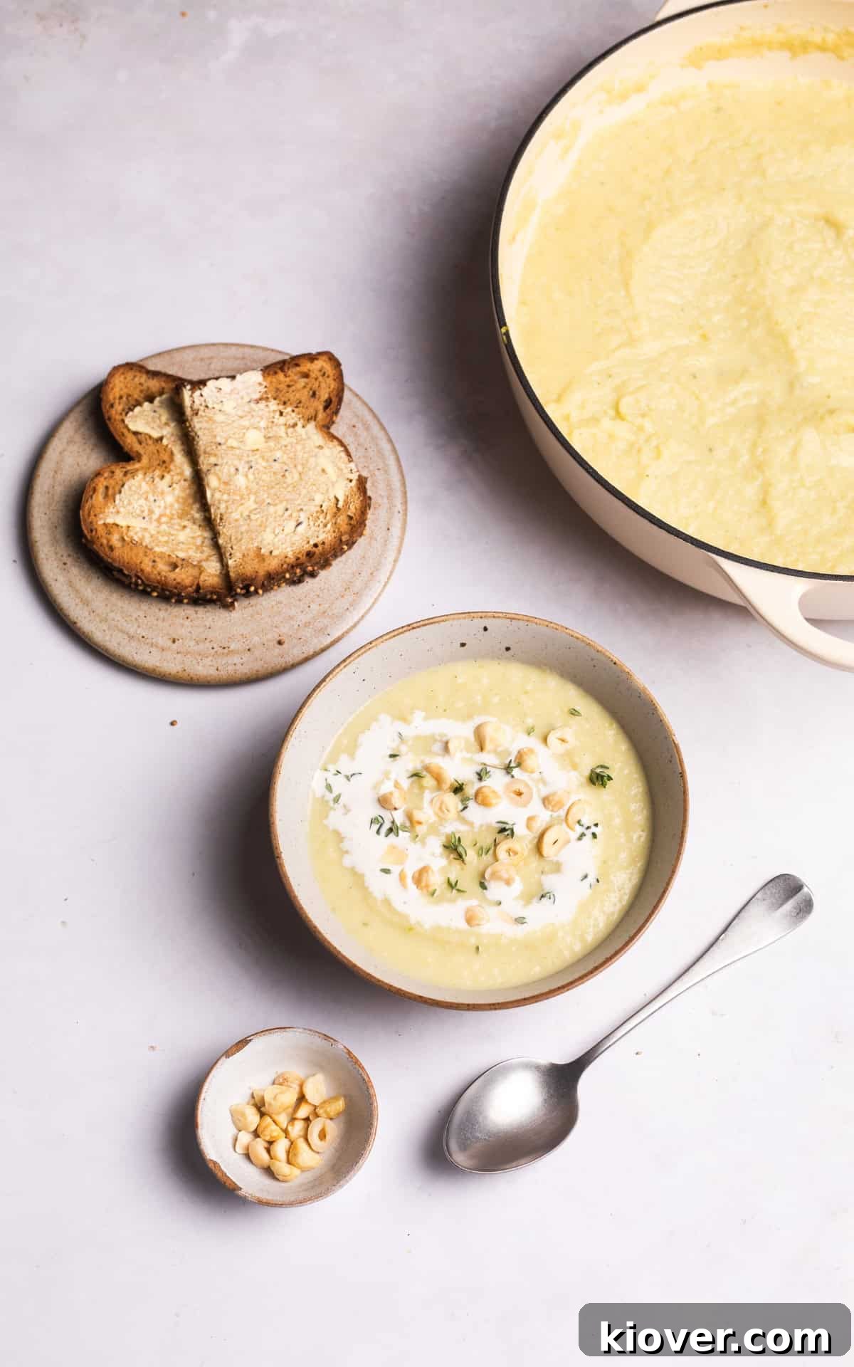 Creamy Celeriac Soup Recipe with Garlic and Thyme 9 creamy celeriac soup served with toast and crushed hazelnuts.