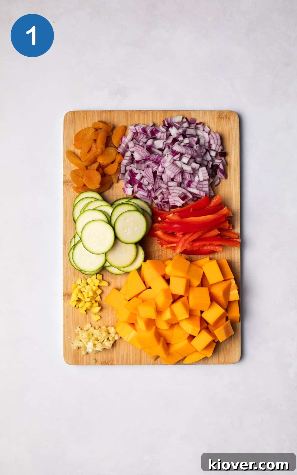 Moroccan Vegetable Tagine Recipe: Flavorful Slow-Cooked Veg Stew 4 Chopped vegetables on a wooden cutting board.