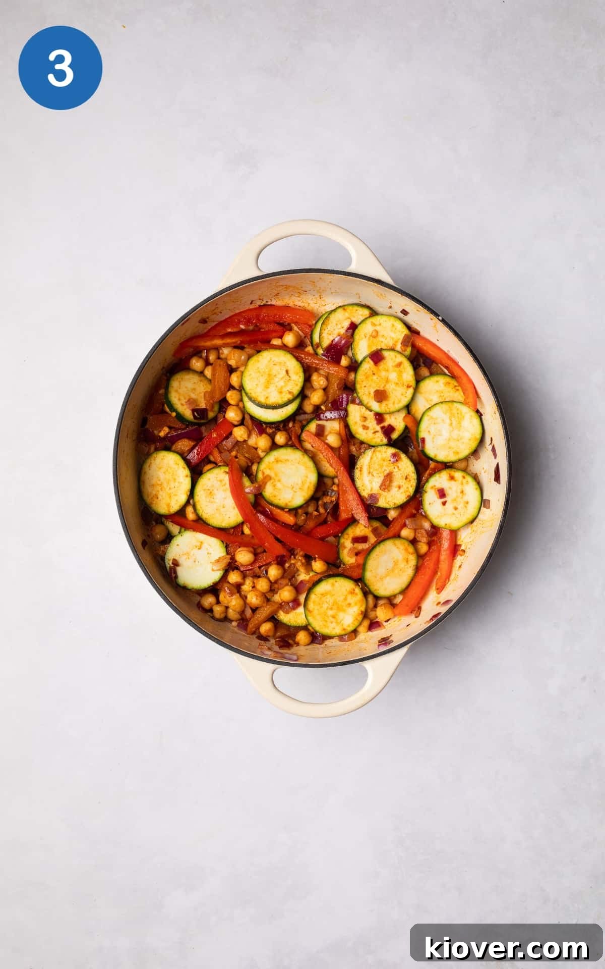 Moroccan Vegetable Tagine Recipe: Flavorful Slow-Cooked Veg Stew 6 Adding vegetables and spices to the cooking pot.