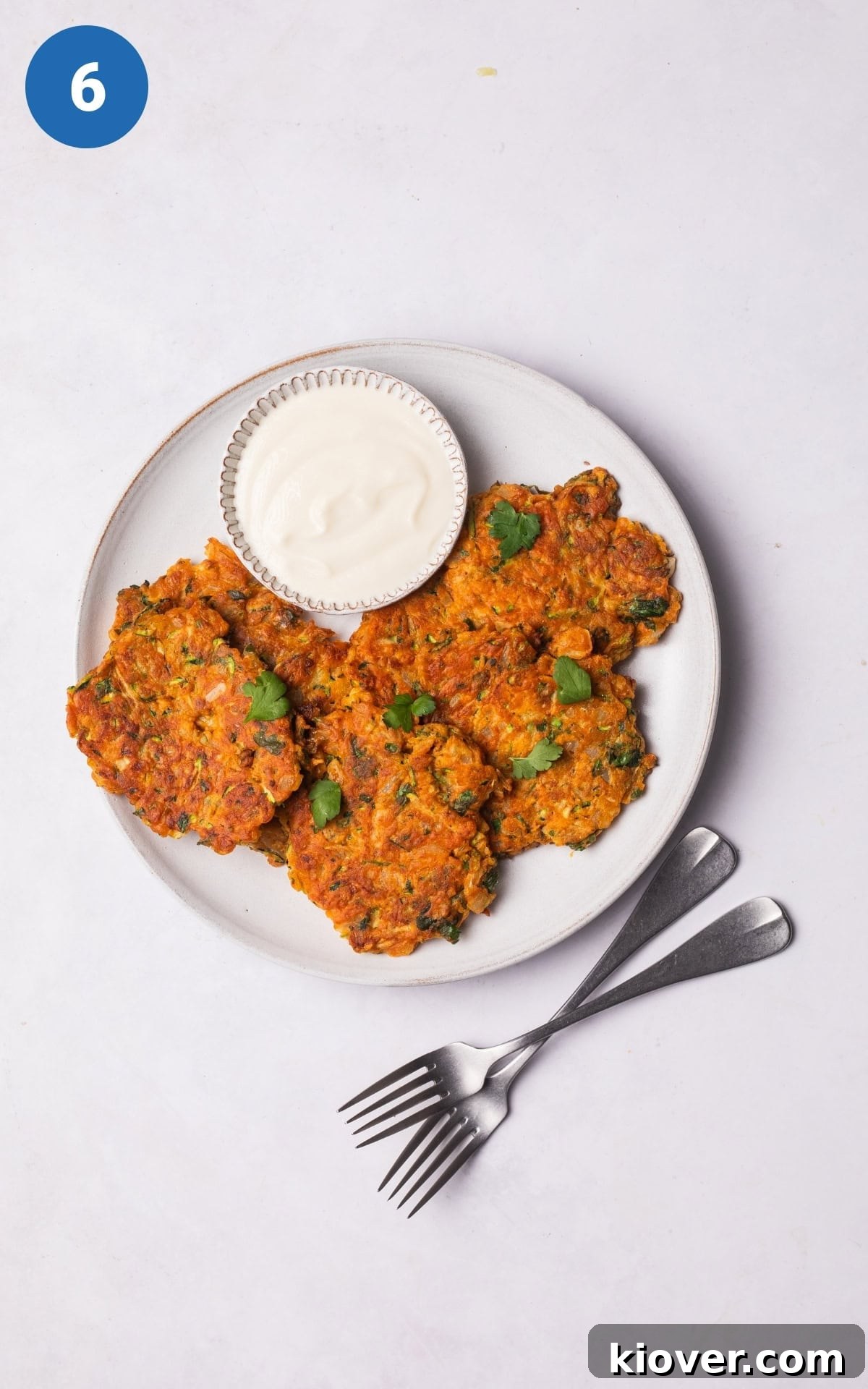Crispy Courgette Fritters with Garlic Yogurt Dip 9 zucchini fritters served on a plate.