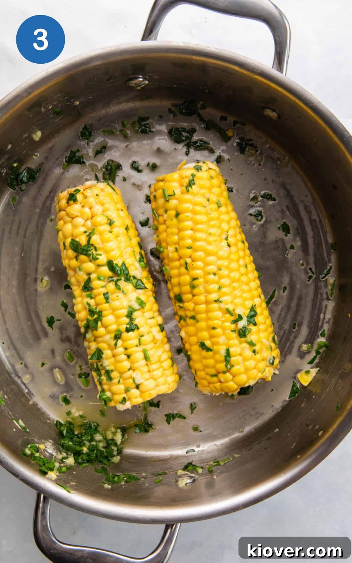 coating the corn with the sauce.