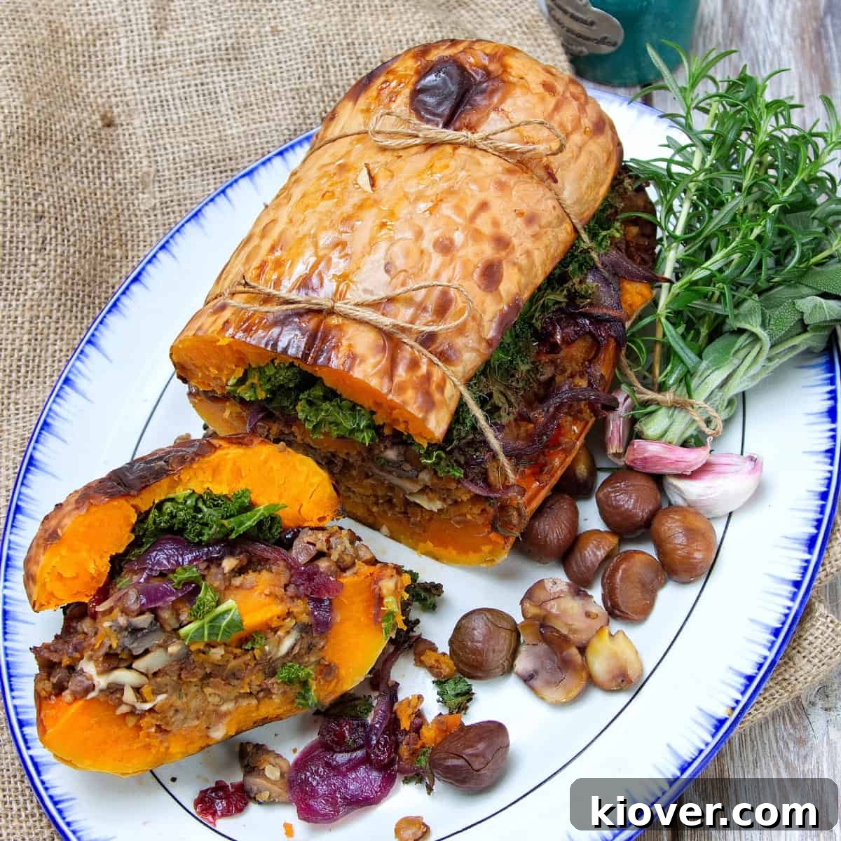 stuffed butternut squash served on a white plate, sliced into.