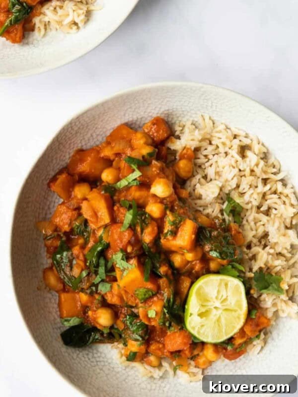 Butternut Squash and Chickpea curry in a bowl with lime