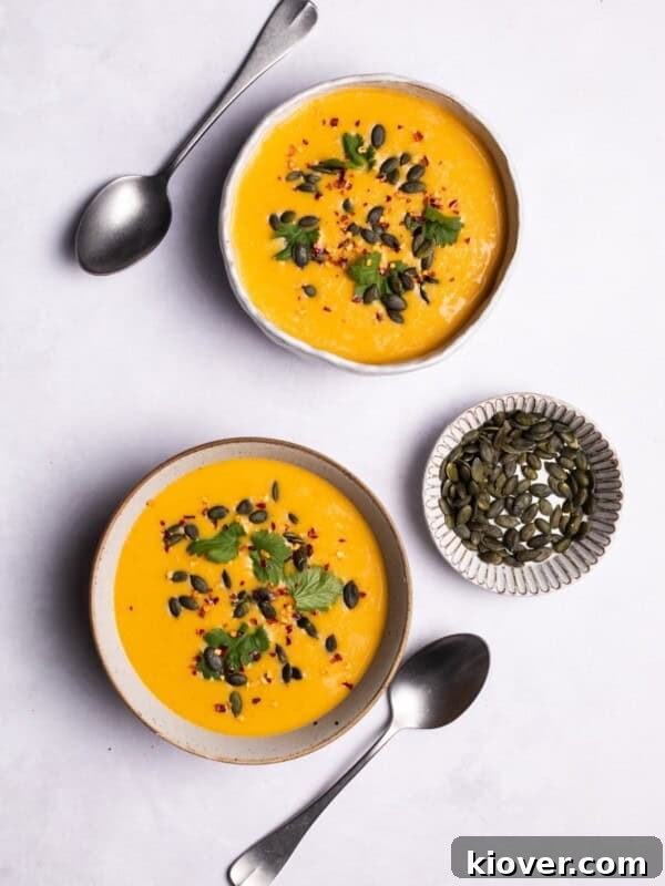 Pumpkin and Butternut Soup served in two white bowls.