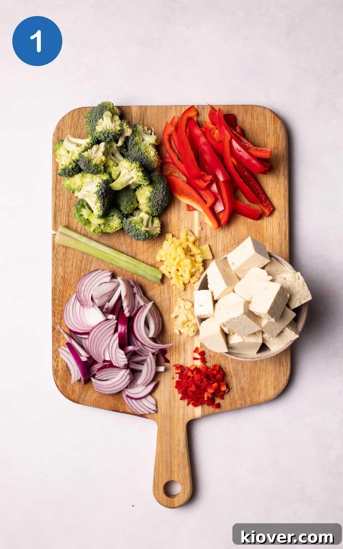 Authentic Vegan Thai Curry Recipe with Creamy Coconut Sauce 4 Vegetables to make Vegan Thai Curry on a wooden chopping board.