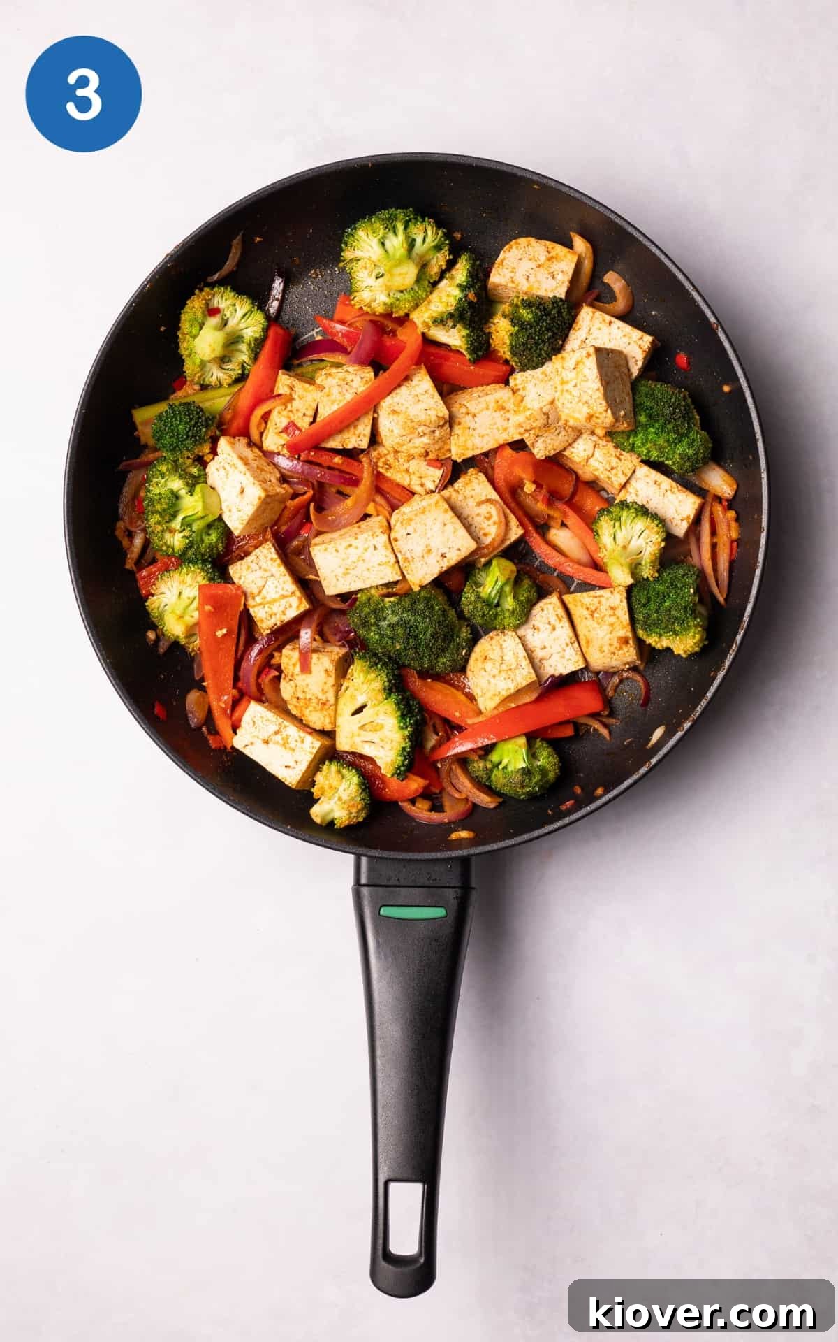 Authentic Vegan Thai Curry Recipe with Creamy Coconut Sauce 6 Tofu, broccoli and pepper added in a pan.