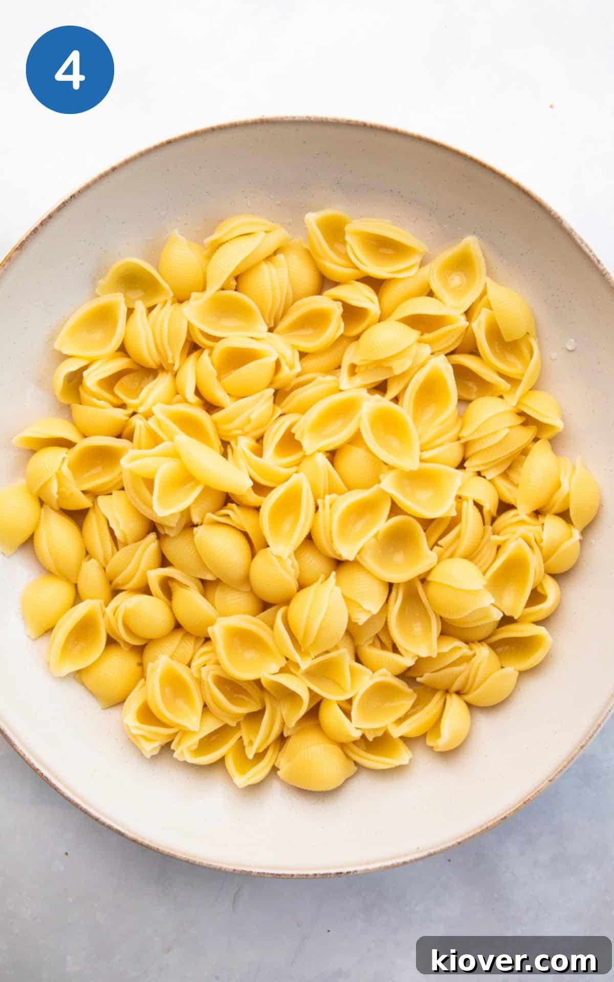 Creamy Tuna Pasta Salad with Lemon and Fresh Herbs 7 drained pasta in a bowl.
