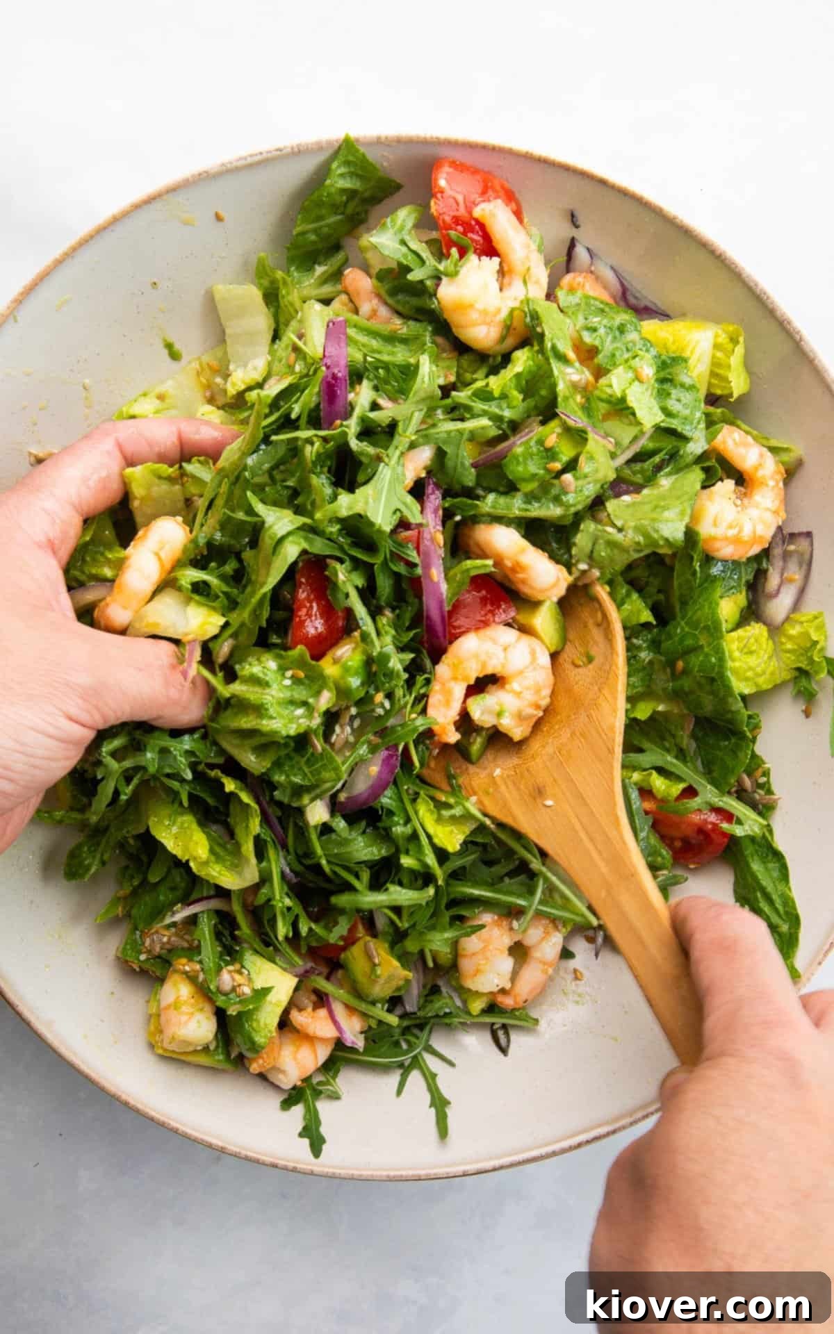 Maple Dijon Vinaigrette Recipe: Sweet and Tangy Salad Dressing 5 mixing prawn salad and dressing with maple syrup and dijon mustard.