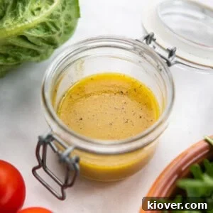 Maple Dijon Vinaigrette Recipe: Sweet and Tangy Salad Dressing 6 dressing with maple syrup and dijon mustard in a glass jar.