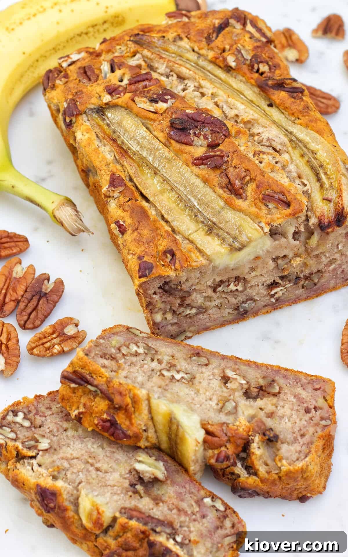 banana bread on white chopping board.