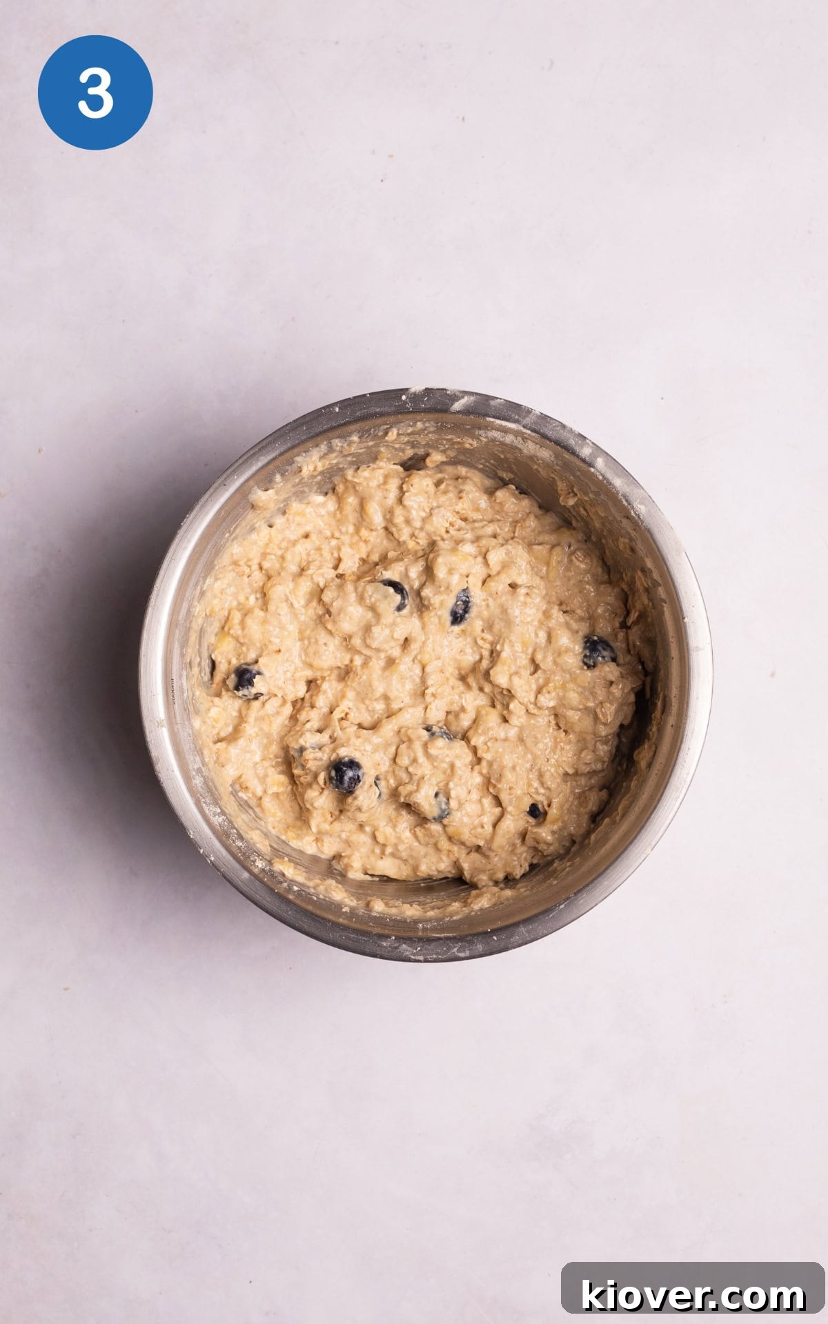 Adding the oat flour, remaining oats, baking powder, and protein powder to the mixture.