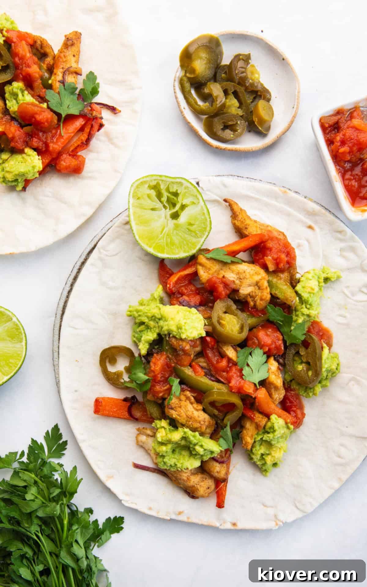 Crispy Air Fryer Chicken Fajitas Recipe for Quick Weeknight Meals 8 chicken fajitas in air fryer served with herbs and lime.
