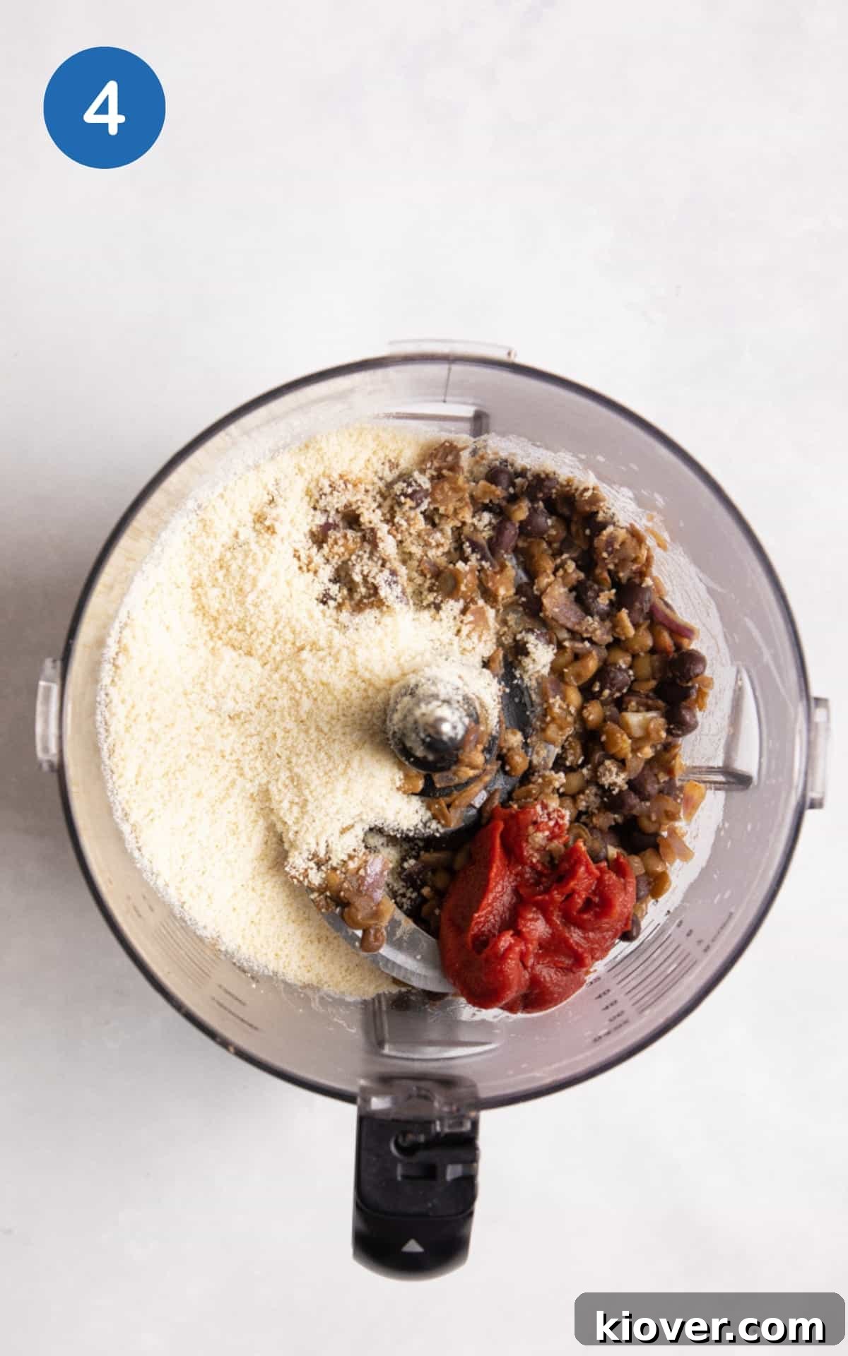 Ingredients to make vegan meatballs being added to a blender.