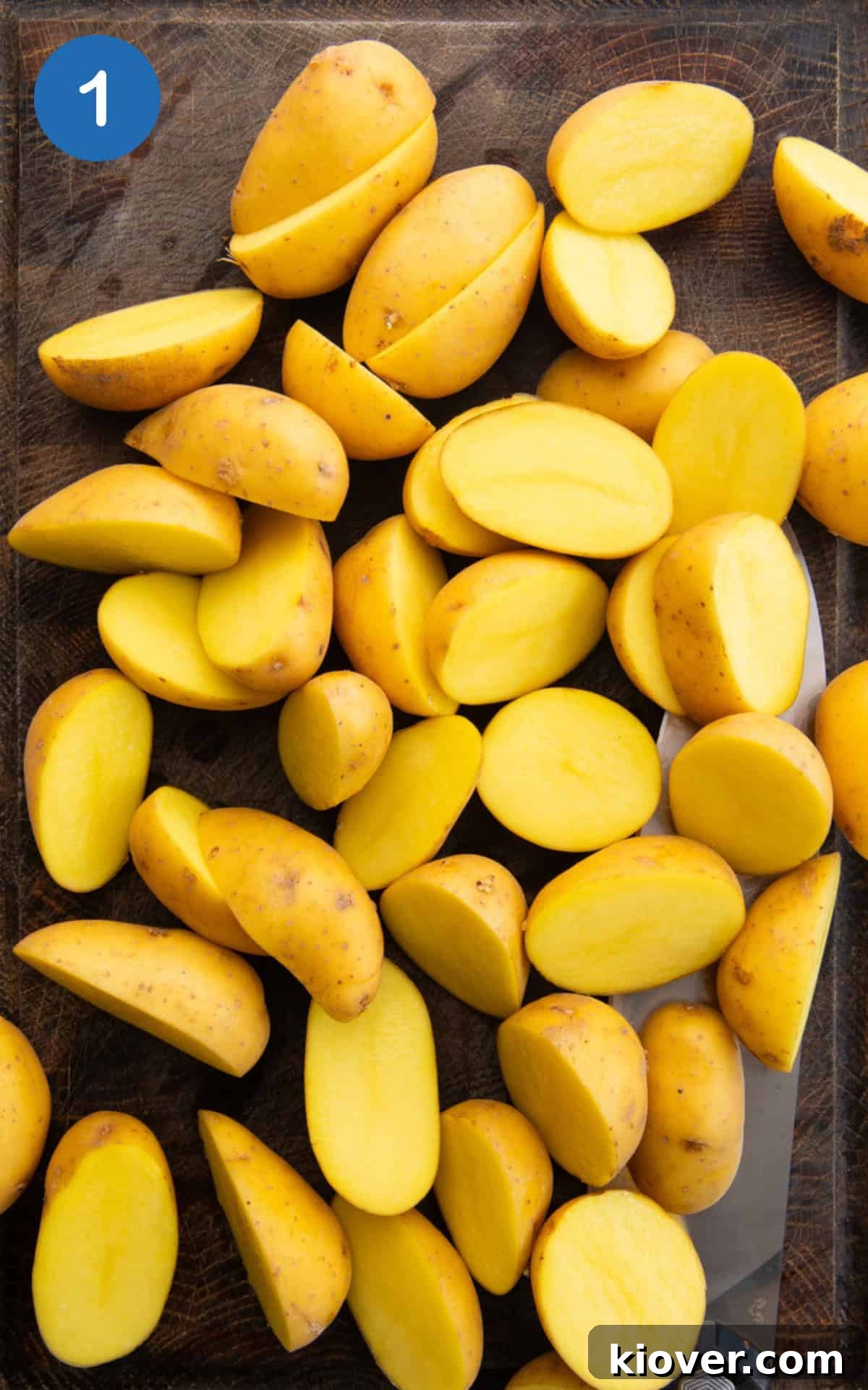 sliced baby potatoes on a cutting board.