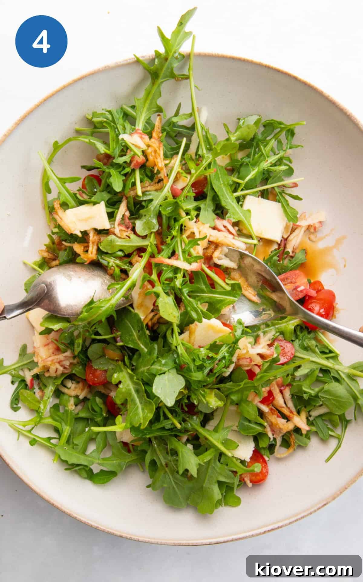 salad with rocket and parmesan cheese with a dressing.