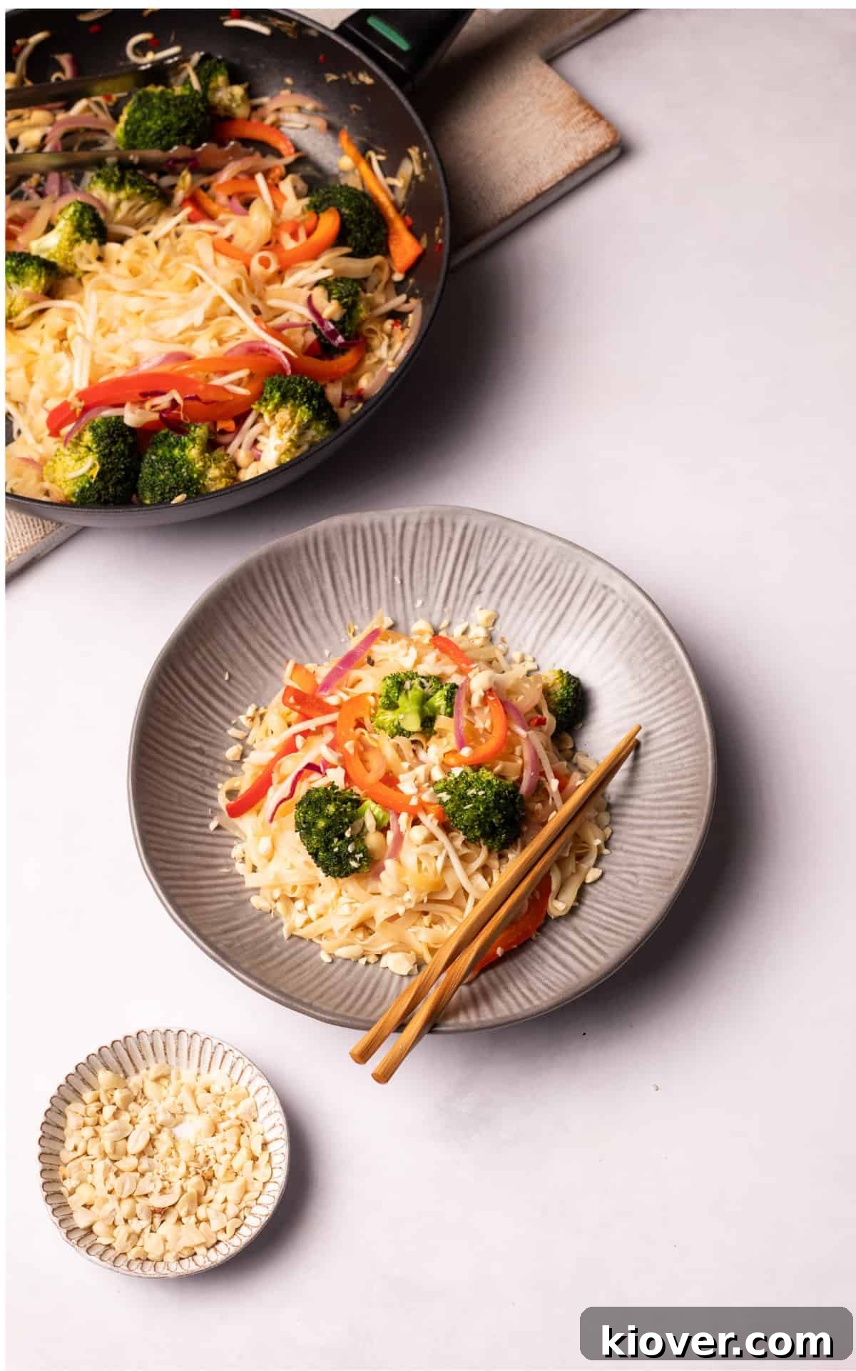 Authentic Vegan Pad Thai Recipe: Flavorful Plant-Based Noodles 9 Vegan Pad Thai served on a plate with wooden chopsticks.