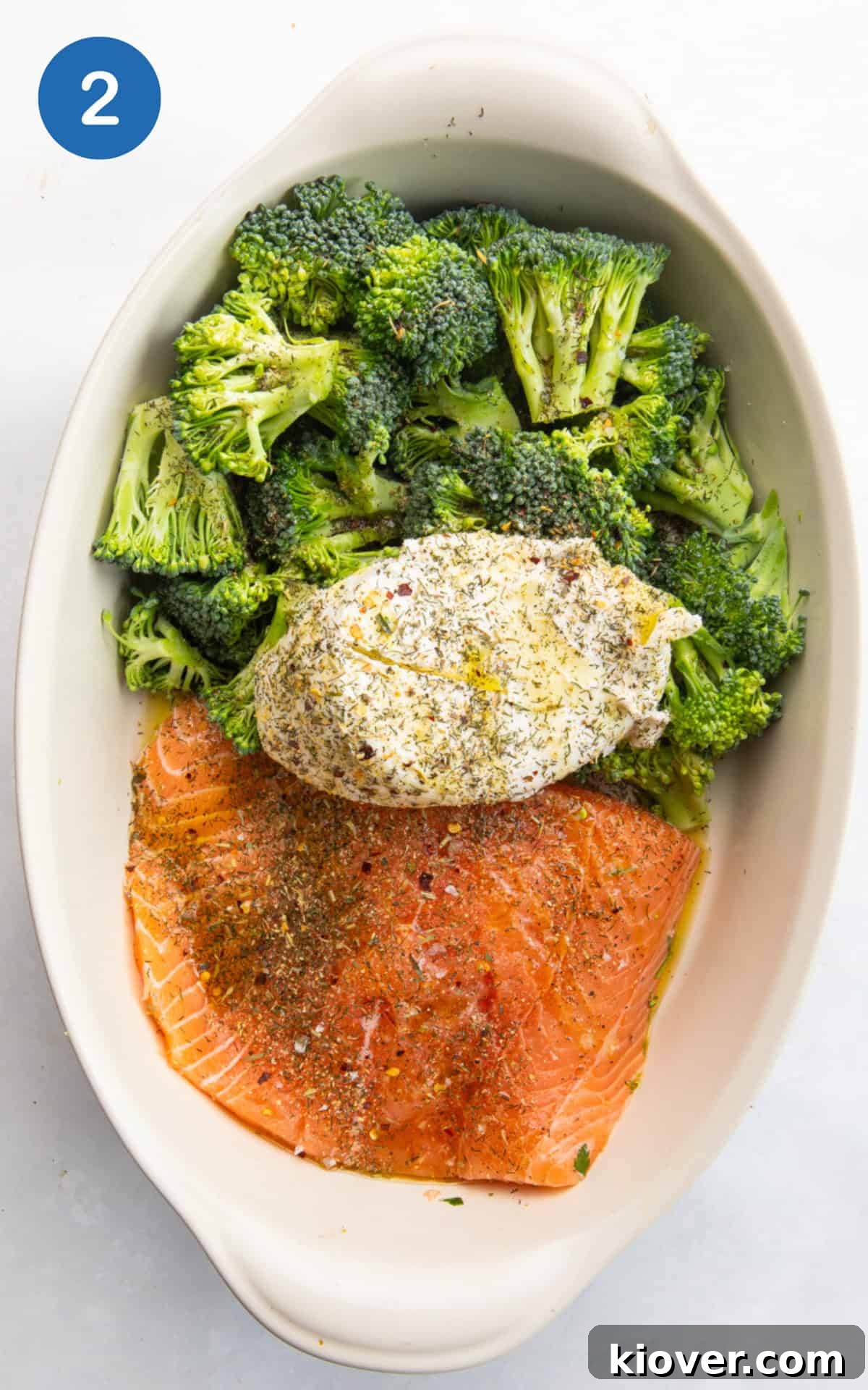 Creamy Salmon & Broccoli Pasta Recipe for Weeknight Dinners 5 salmon, broccoli and cream cheese with spices in a baking dish.