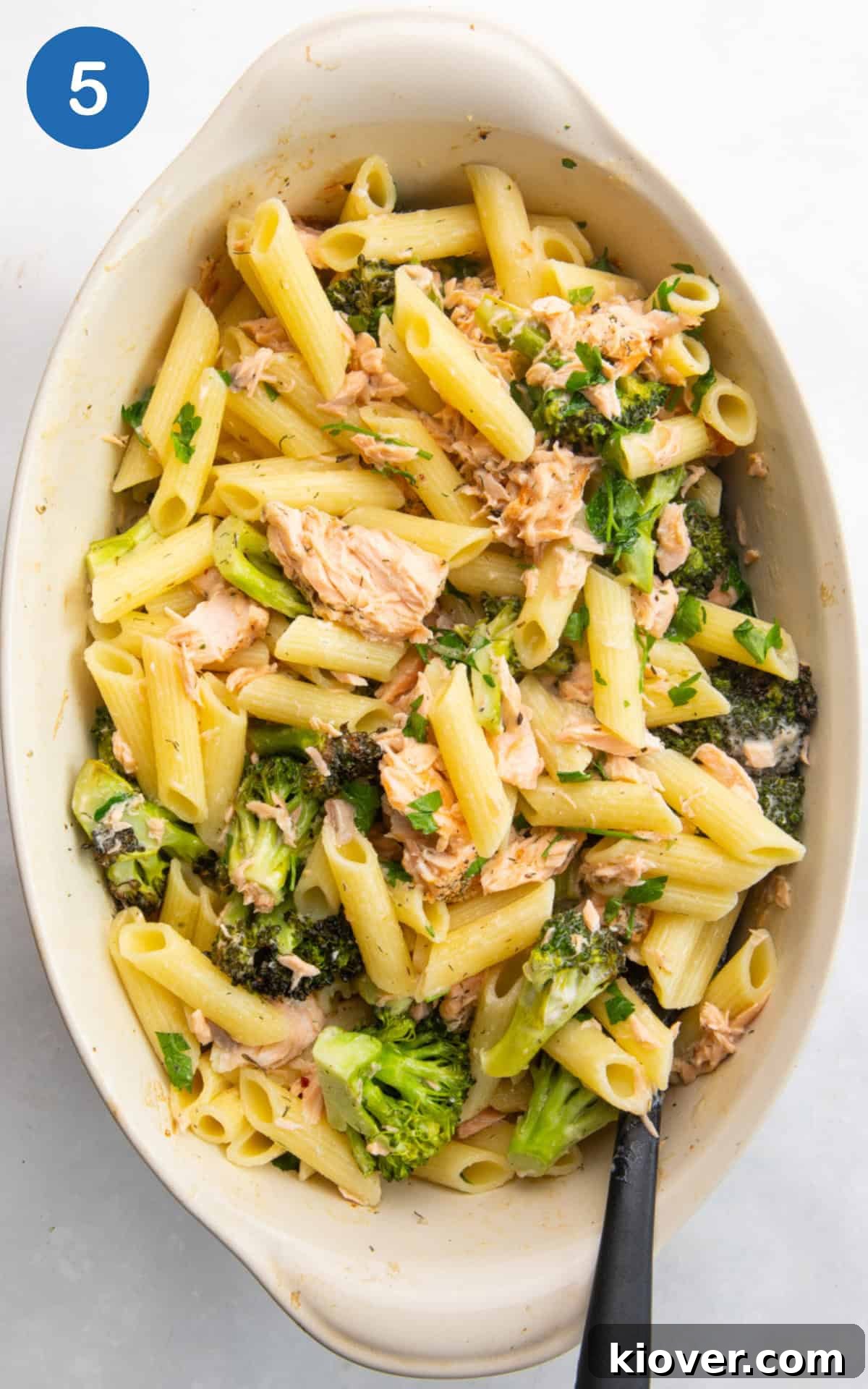 Creamy Salmon & Broccoli Pasta Recipe for Weeknight Dinners 8 adding pasta to the baking dish along with the lemon juice and chopped parsley.