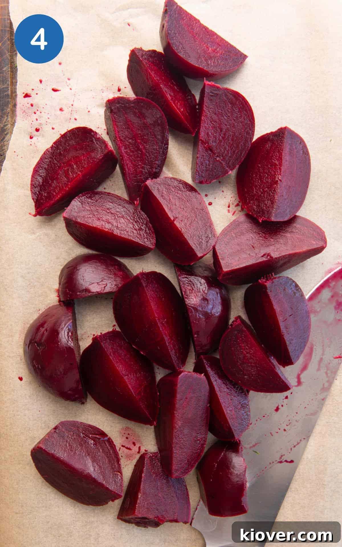 Sliced quarters of beetroot on a baking sheet.