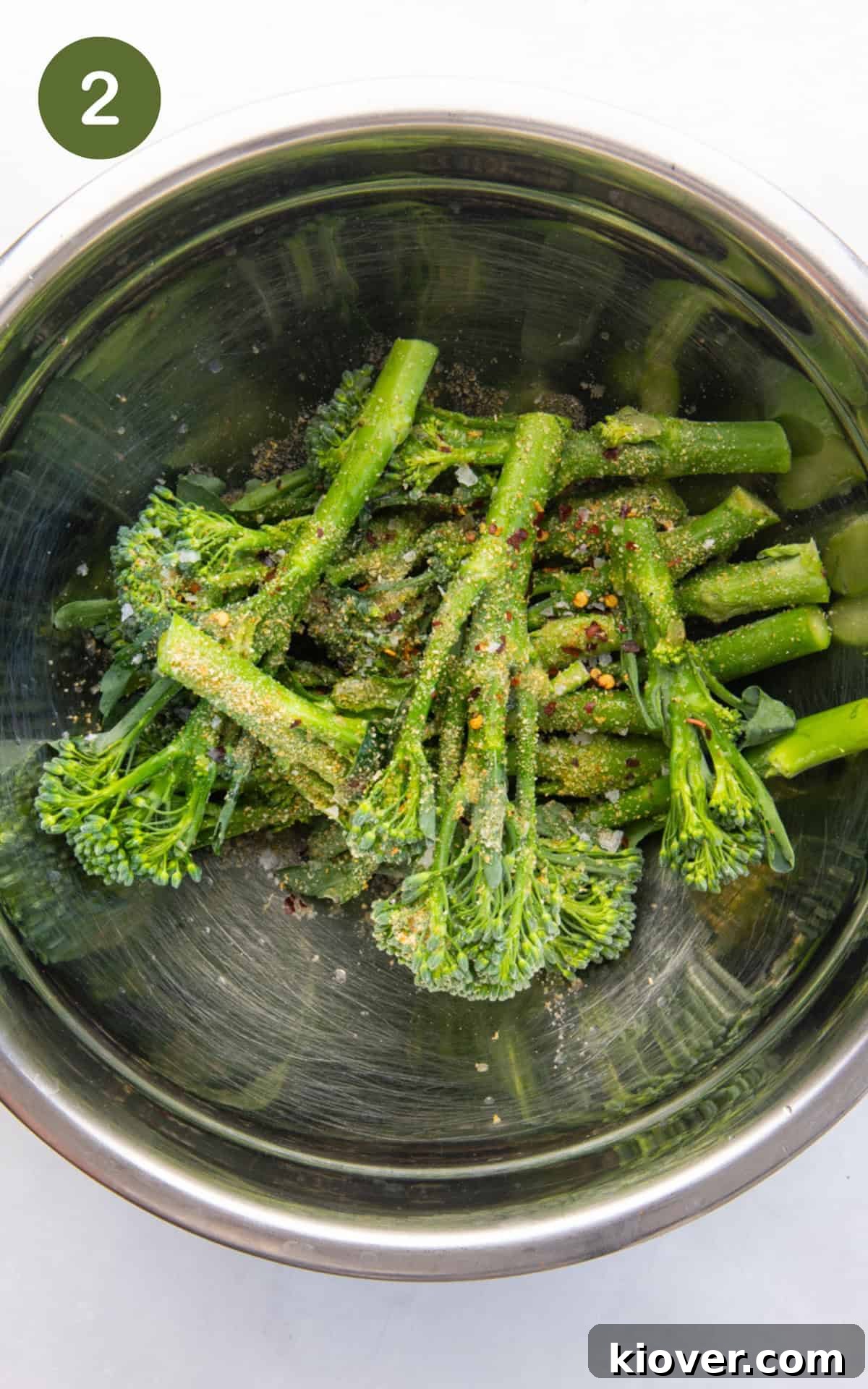 mixing broccoli florets with olive oil, garlic powder, onion powder, red pepper flakes, lemon juice and a generous pinch of salt and pepper.