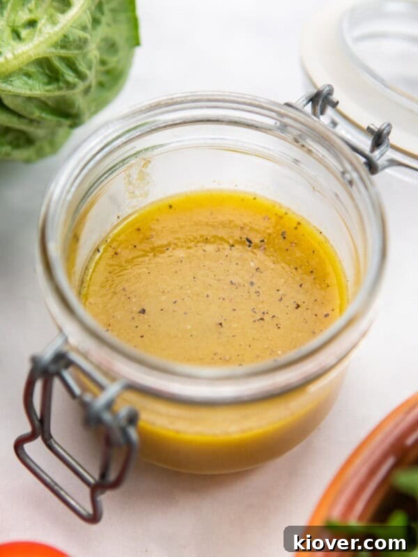 dressing with maple syrup and dijon mustard in a glass jar.