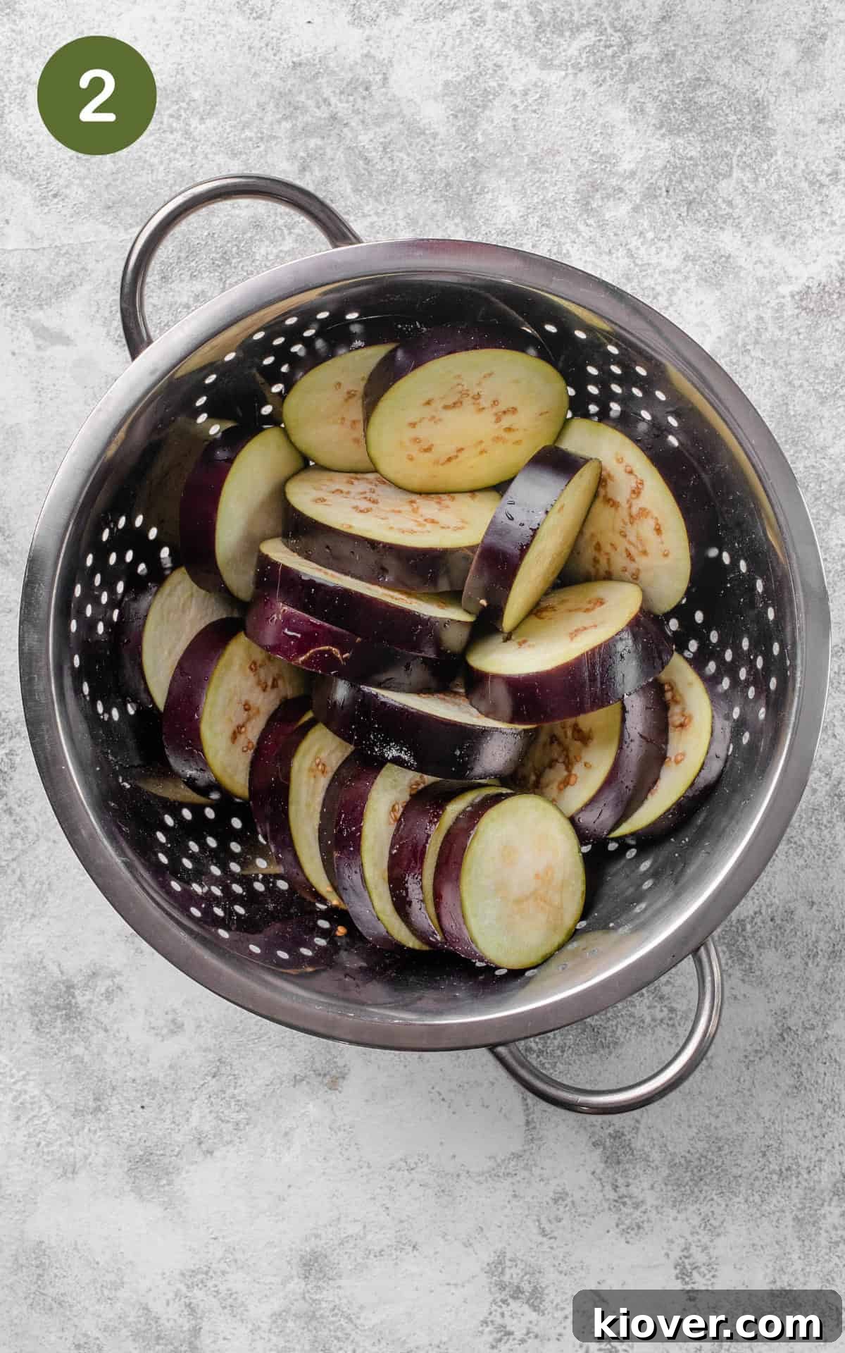 Smoky Roasted Eggplant Salad with Garlic and Herbs 5 aubergines in a colander seasoned with salt.