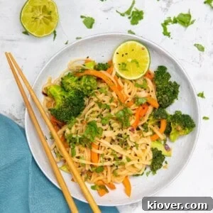 peanut butter noodles with vegetables in a bowl.
