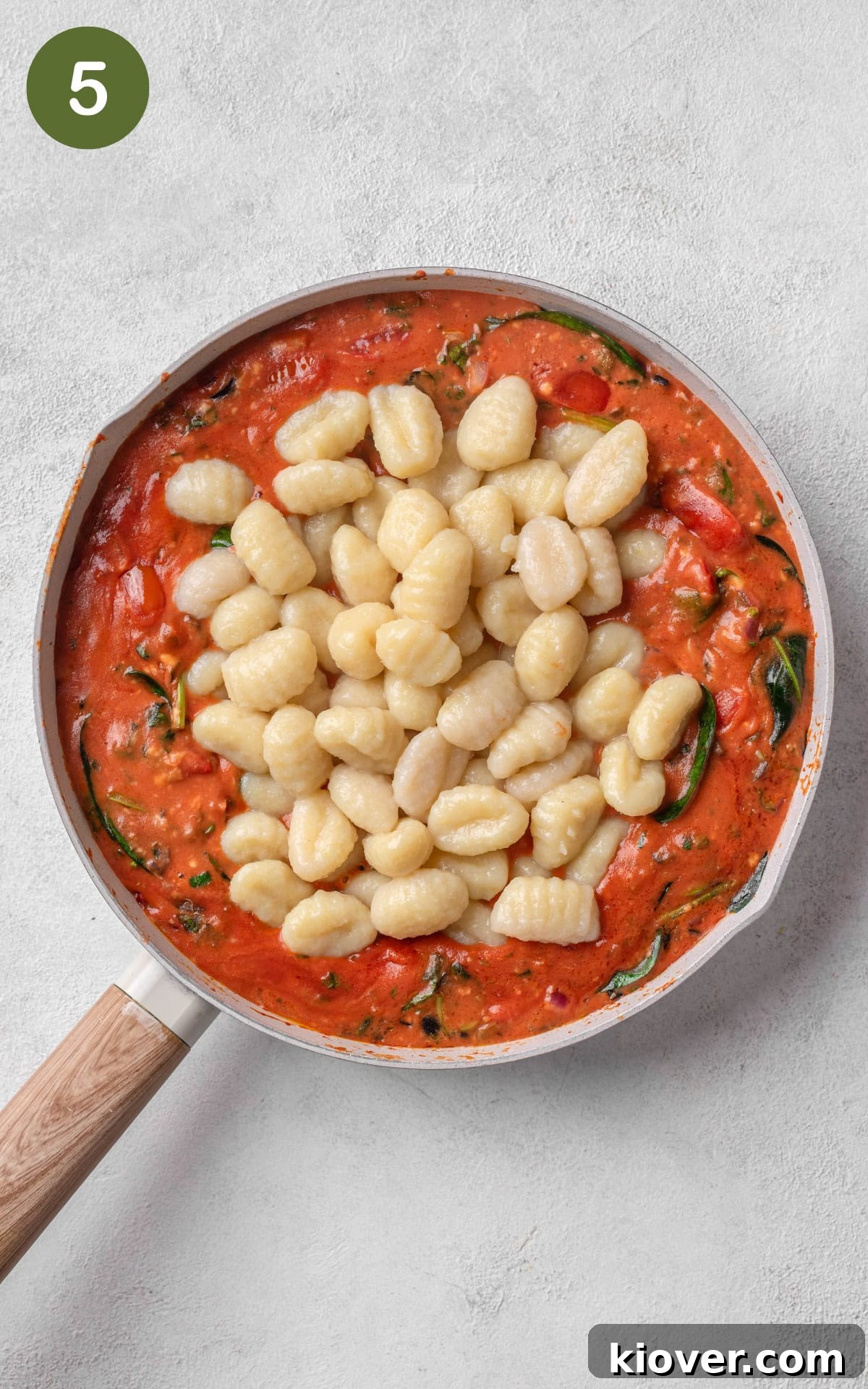Creamy Baked Gnocchi with Mozzarella and Tomato Sauce 8 Gnocchi in red sauce in a skillet.