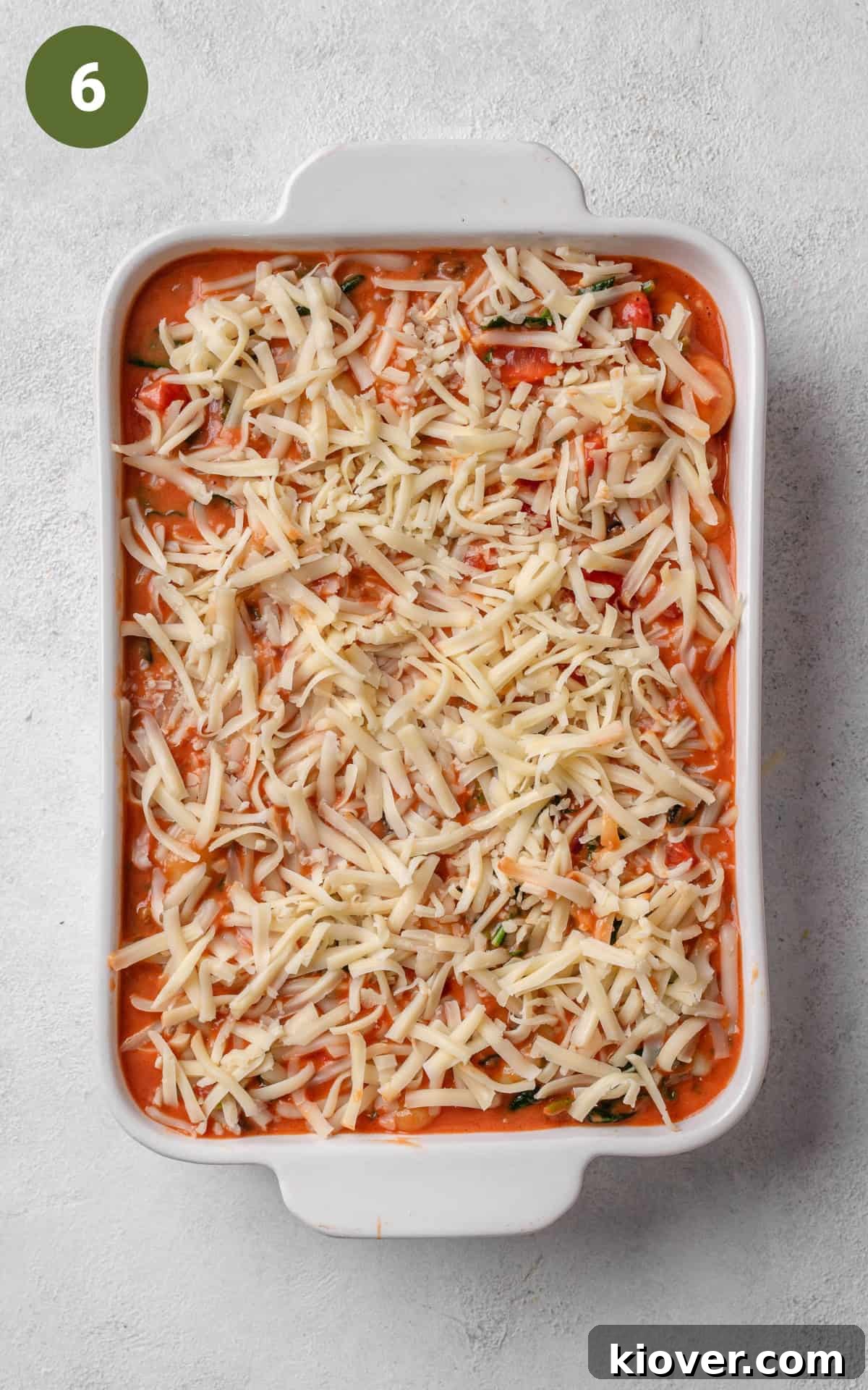 Creamy Baked Gnocchi with Mozzarella and Tomato Sauce 9 Red sauce with cheese on top in a baking dish.