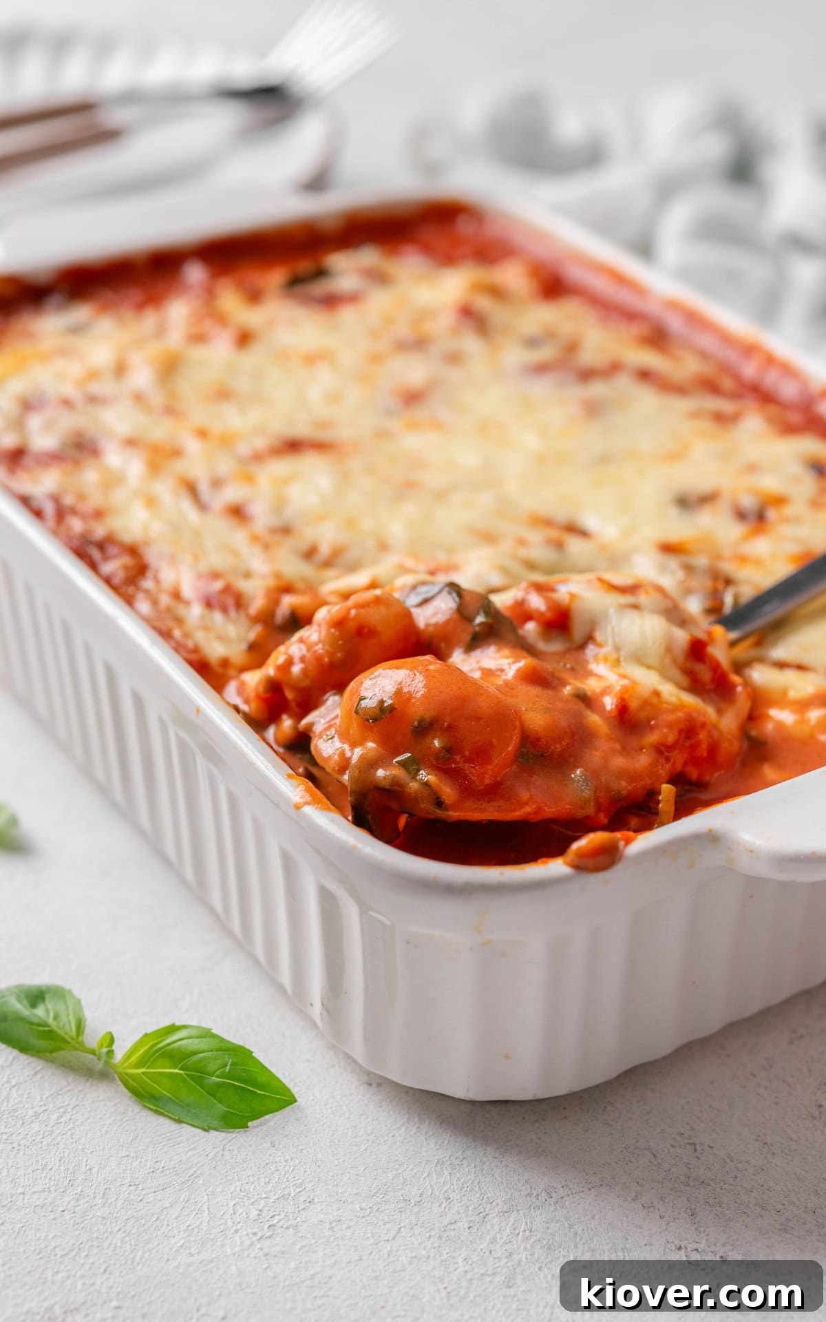 Creamy Baked Gnocchi with Mozzarella and Tomato Sauce 10 Gnocchi in red sauce with cheese on top in a baking dish.