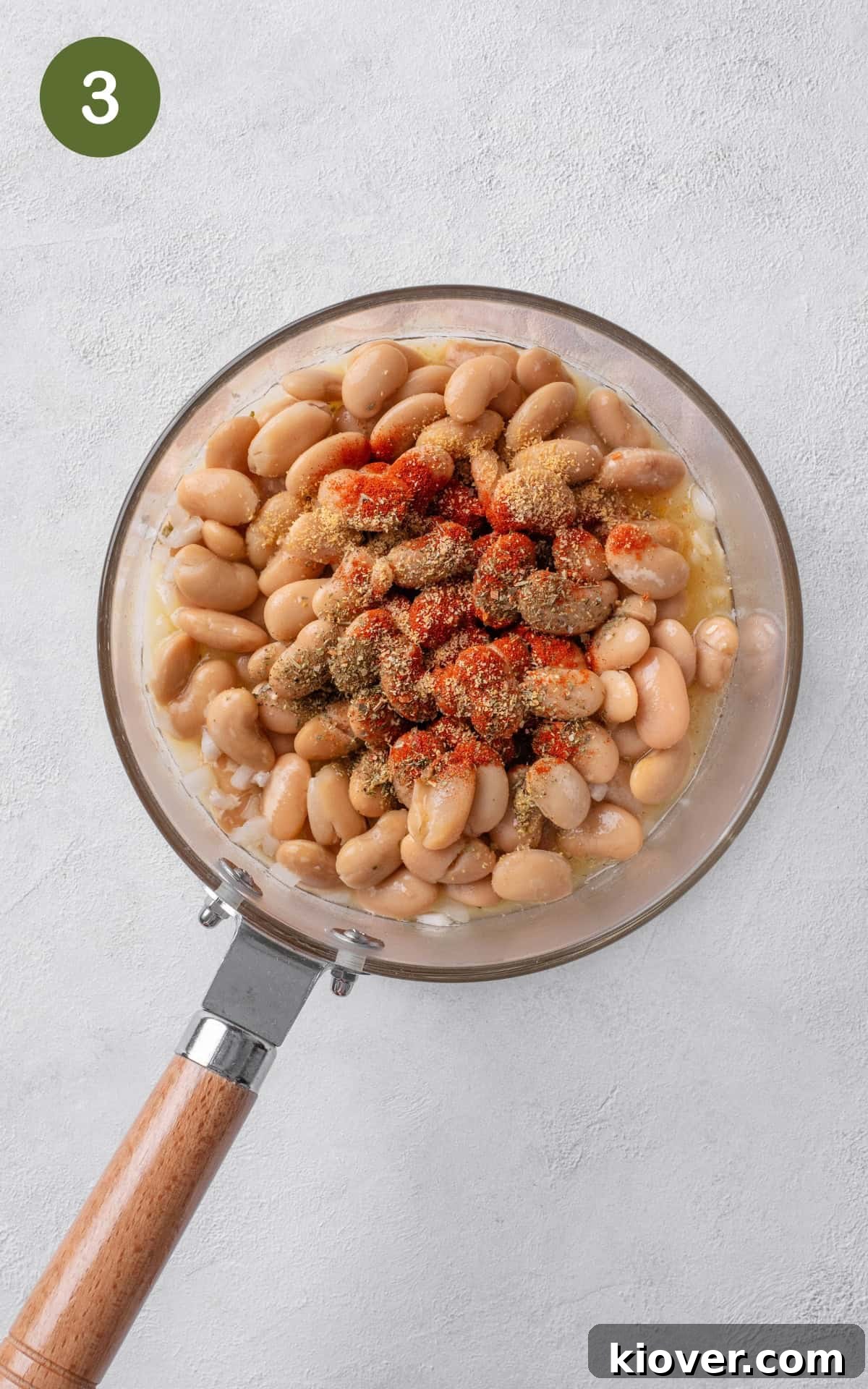 Creamy Butterbean Stew with Garlic and Herbs 6 adding drained butterbeans, paprika, Italian seasoning, mustard powder and vegetable stock to the pot.