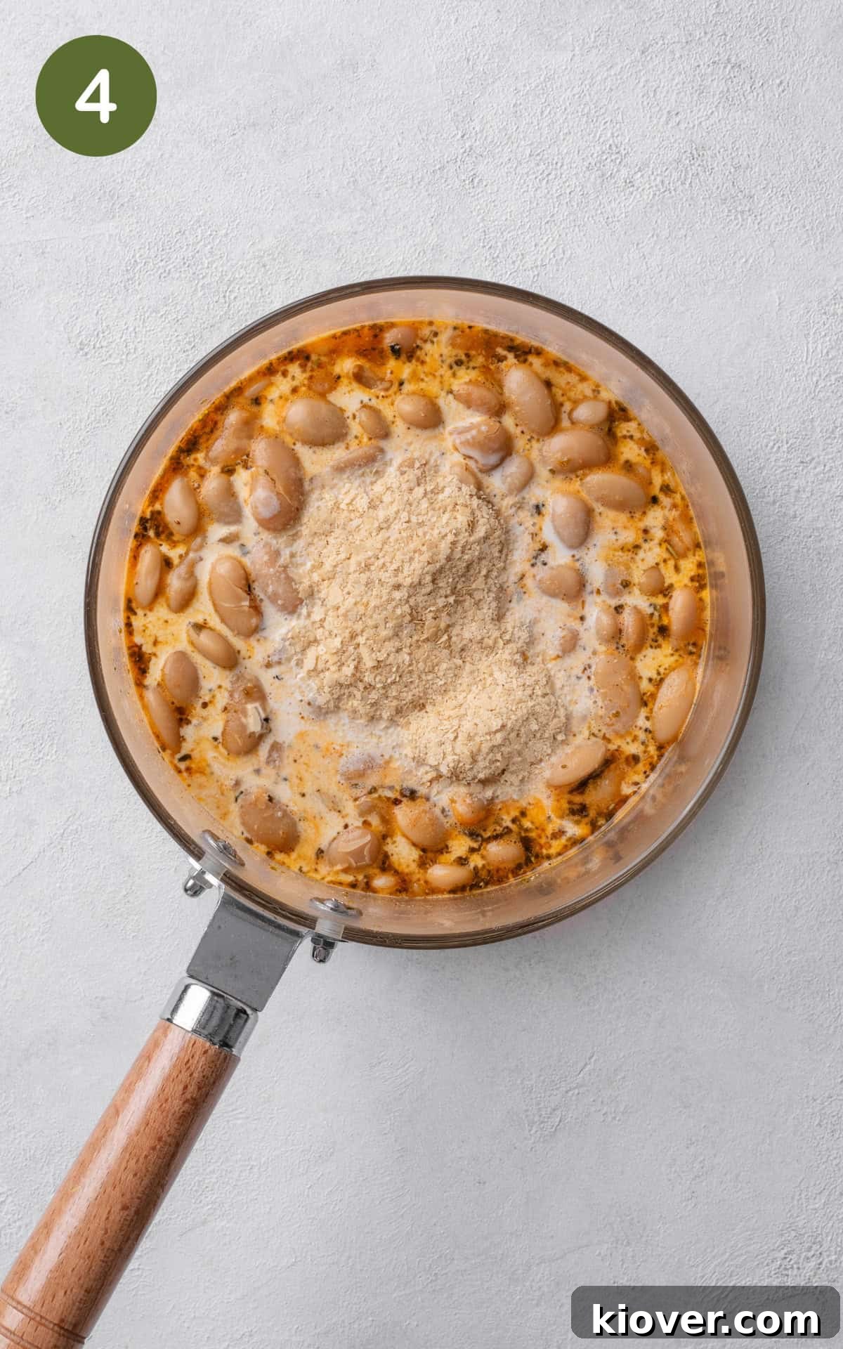 Creamy Butterbean Stew with Garlic and Herbs 7 Adding the cream and nutritional yeast to the pot.