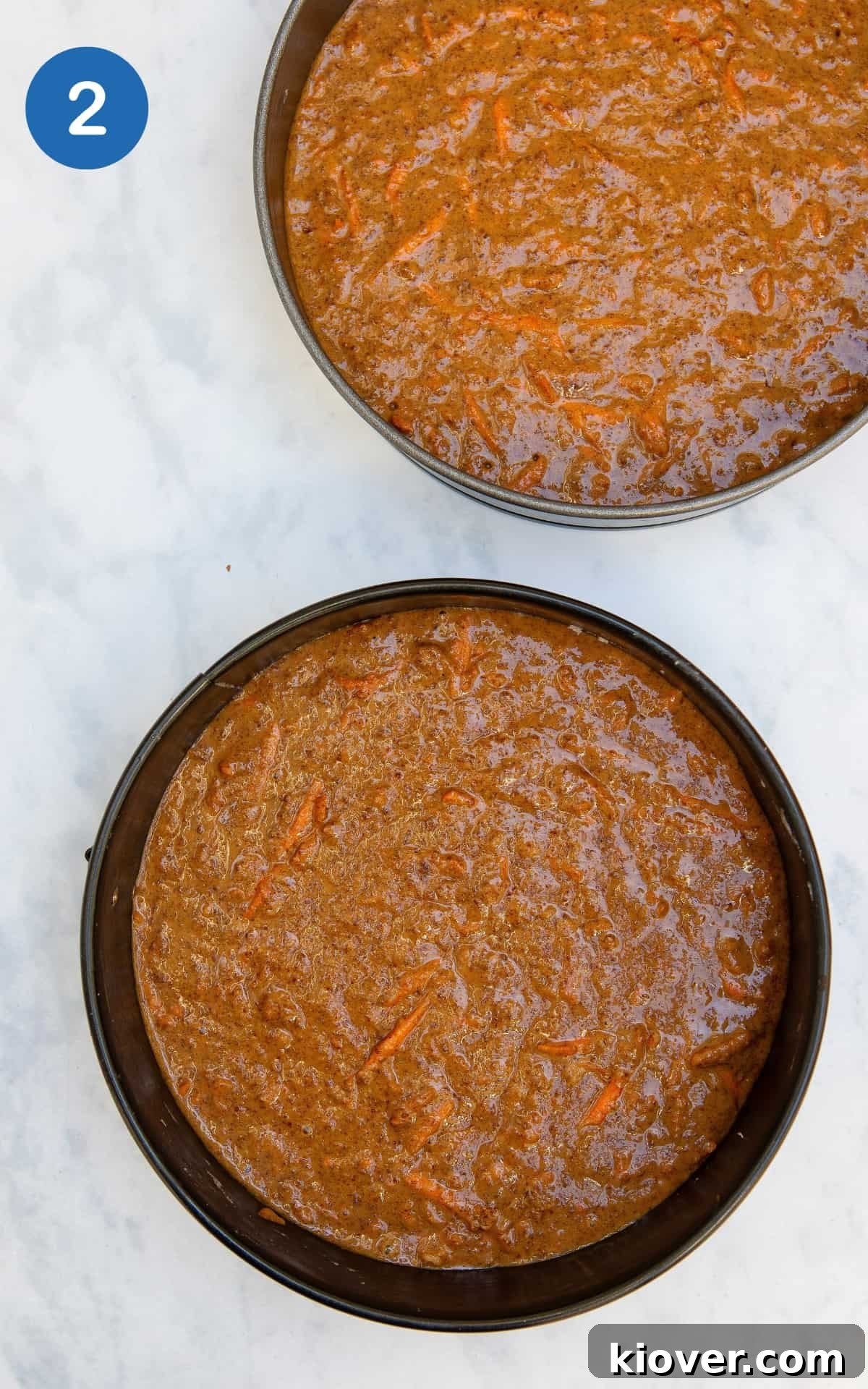 carrot cake batter in 2 tins ready for baking.