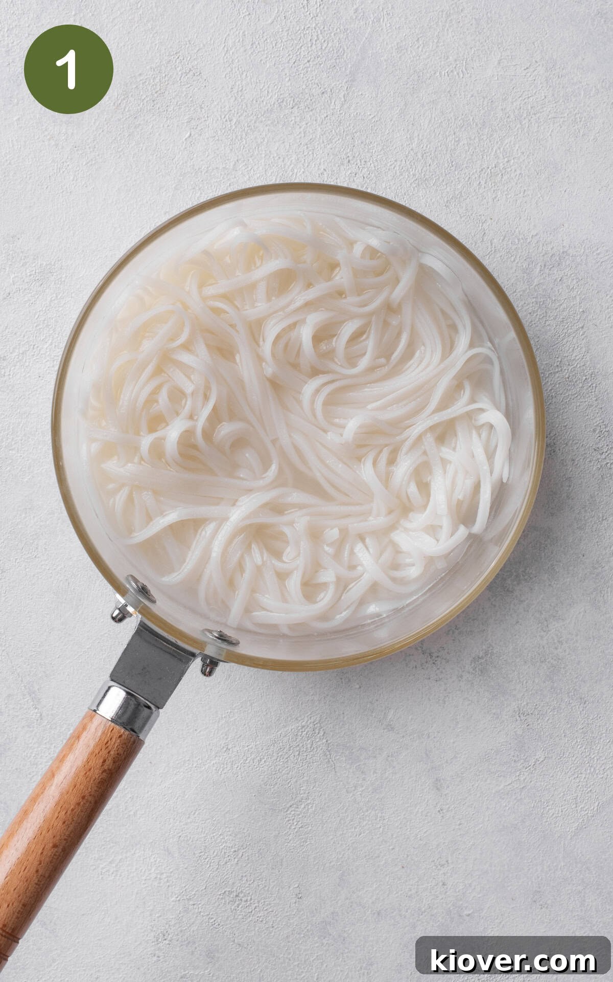 cooking rice noodles in a pot.