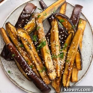 Air Fryer Aubergine sprinkled with sesame seeds.