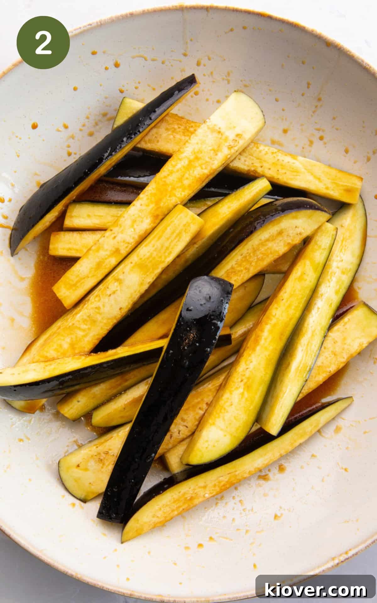 mixing the eggplant with tamari, maple syrup and sesame oil.