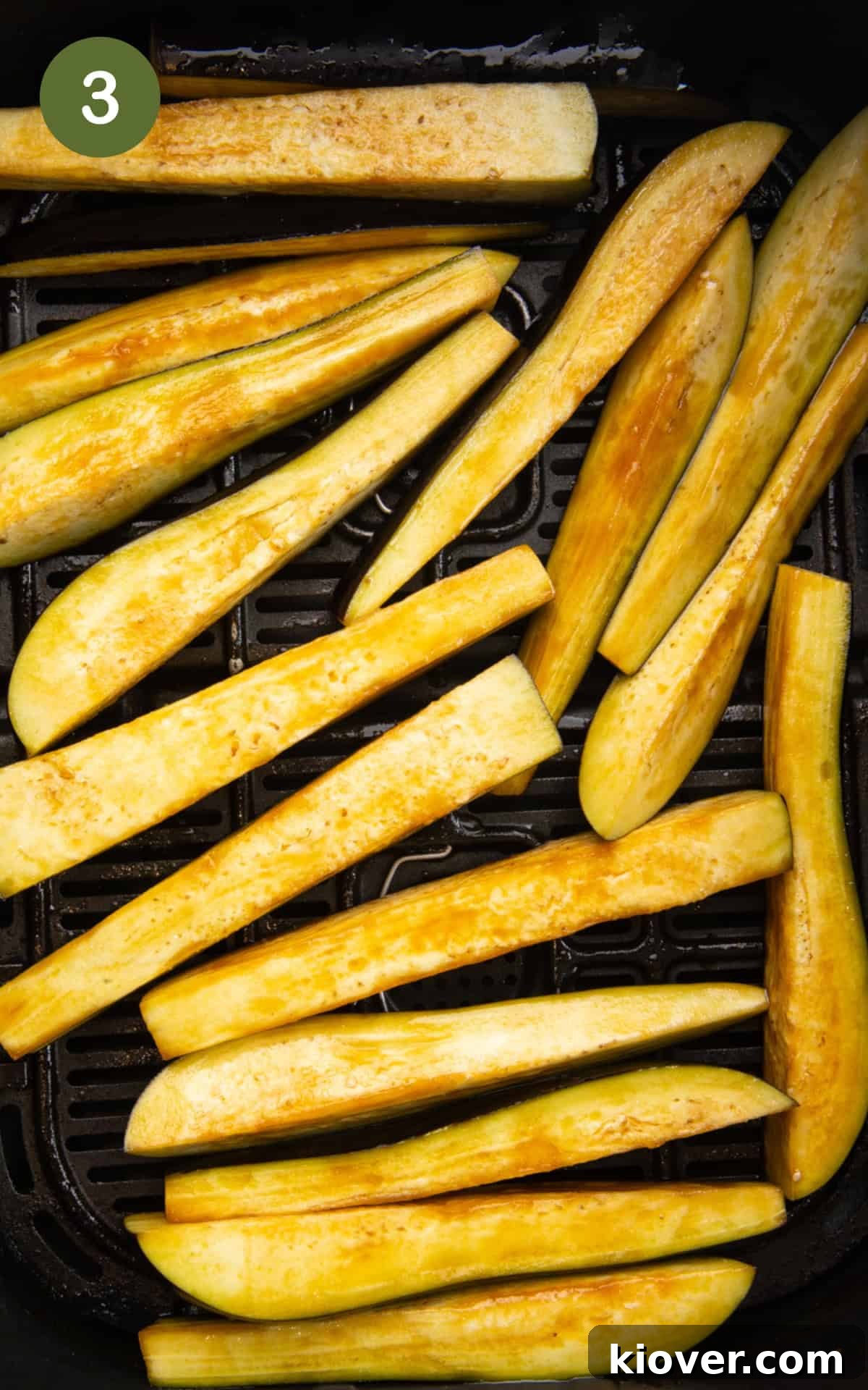 aubergine slices in the air fryer basket.