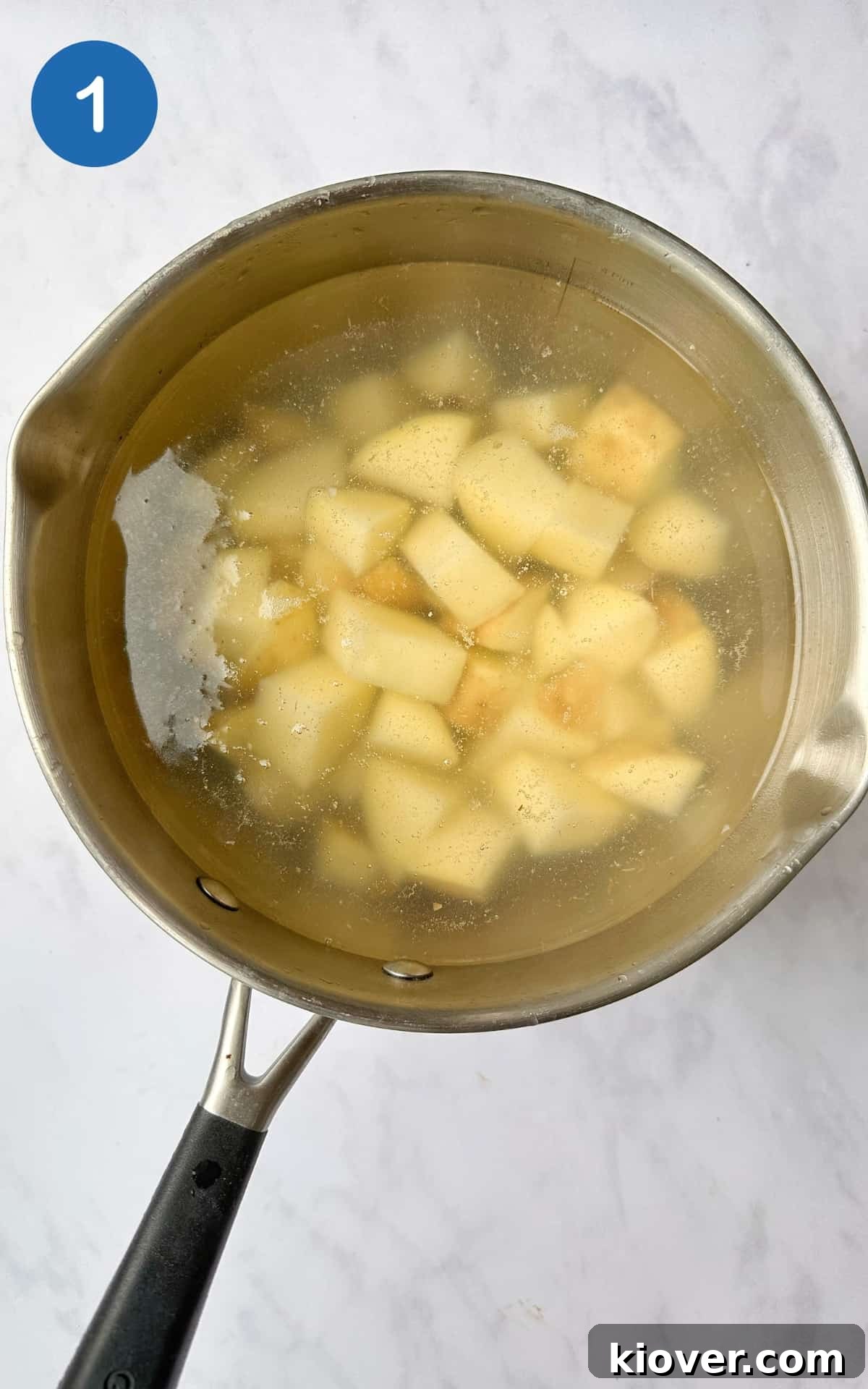 White potatoes in a pot with water.