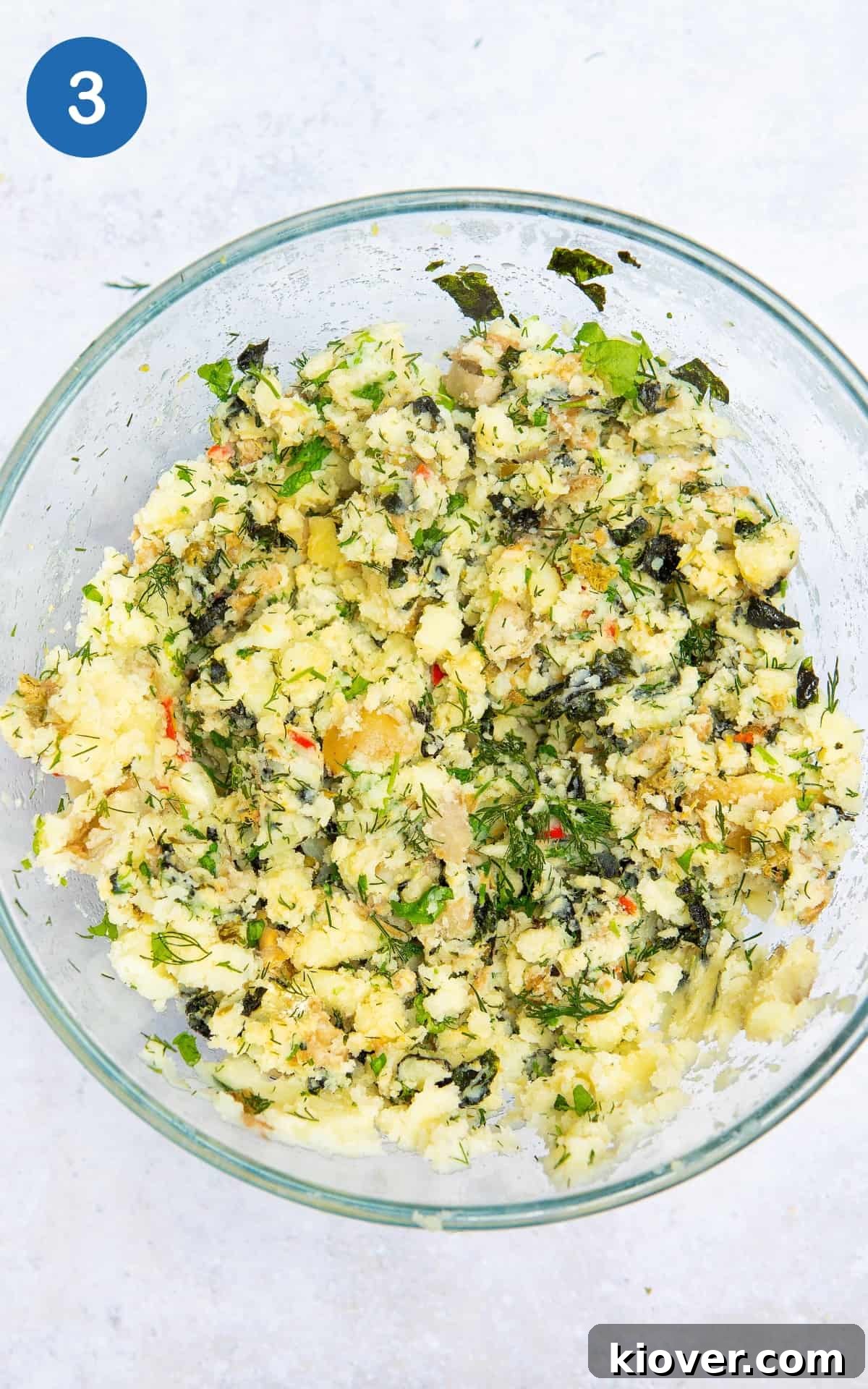 White potatoes in a bowl combined with other ingredients to make Vegan Fishcakes.