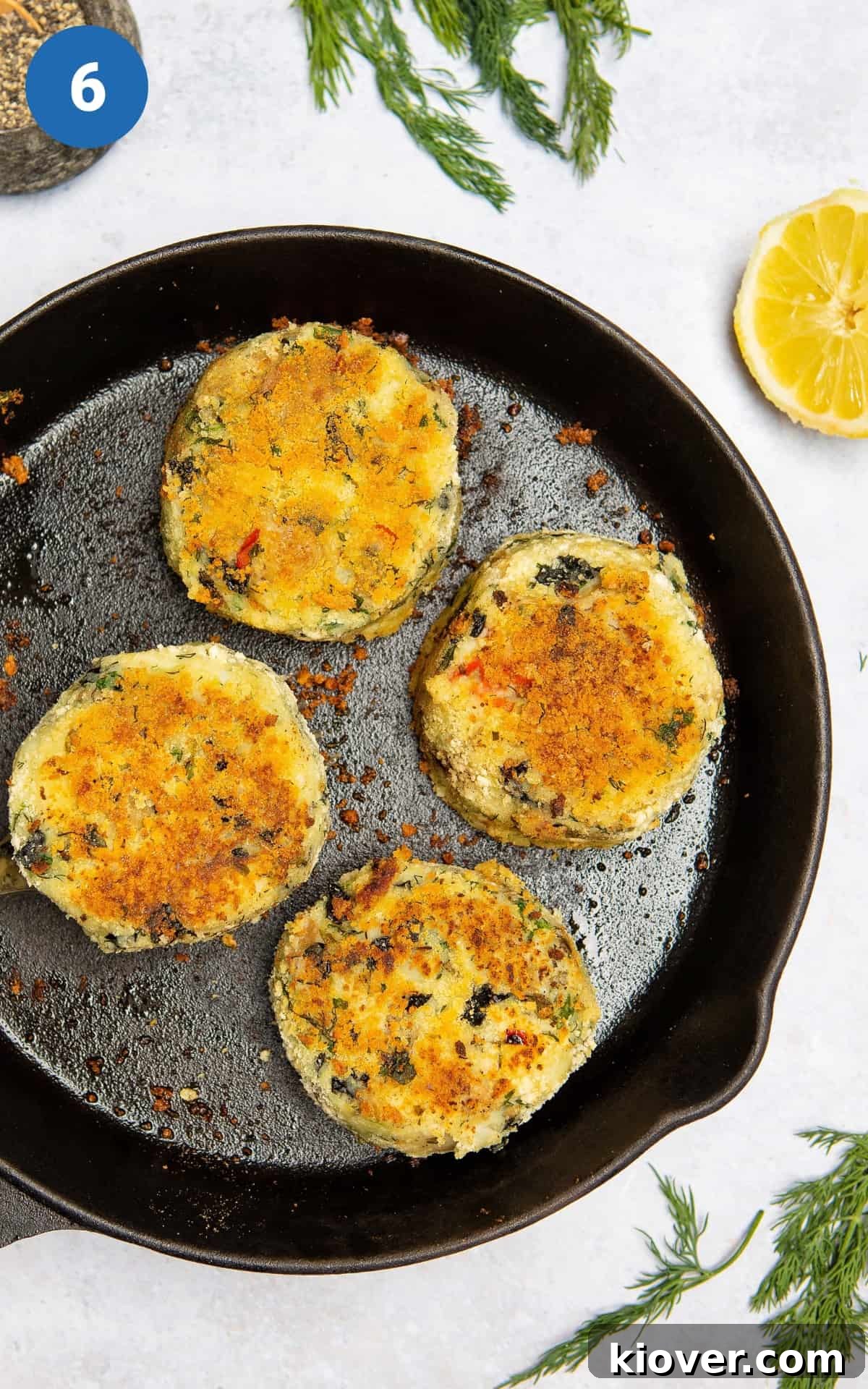 Golden brown vegan fishcakes in a pan.