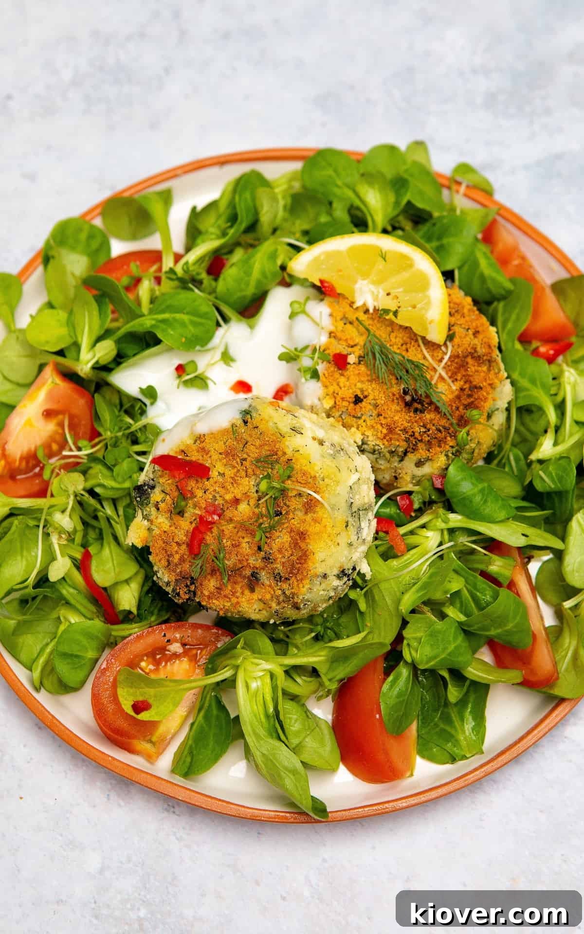 Vegan fishcakes served on a plate with fresh vegetables.