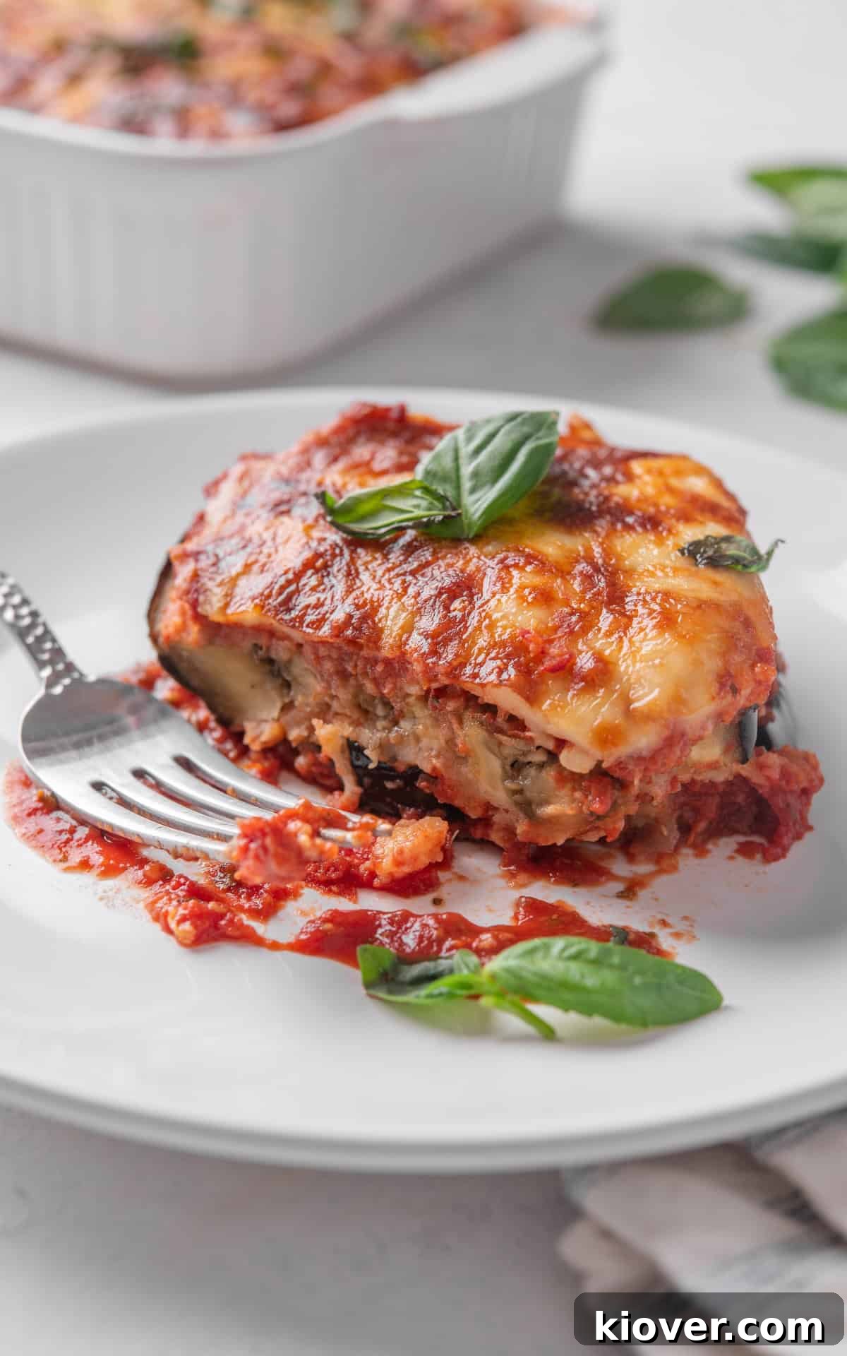 Eggplant Parmigiana Recipe: Classic Italian Melanzane alla Parmigiana 10 slice of aubergine parmigiana on a plate.