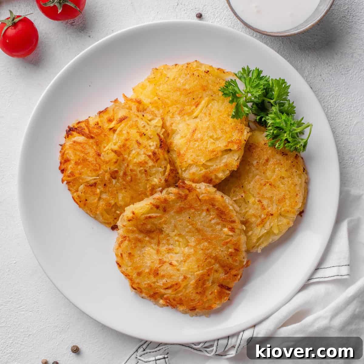 Crispy Swiss Potato Rösti Recipe — Golden Hash Brown Style 2 potato rosti served on a plate.