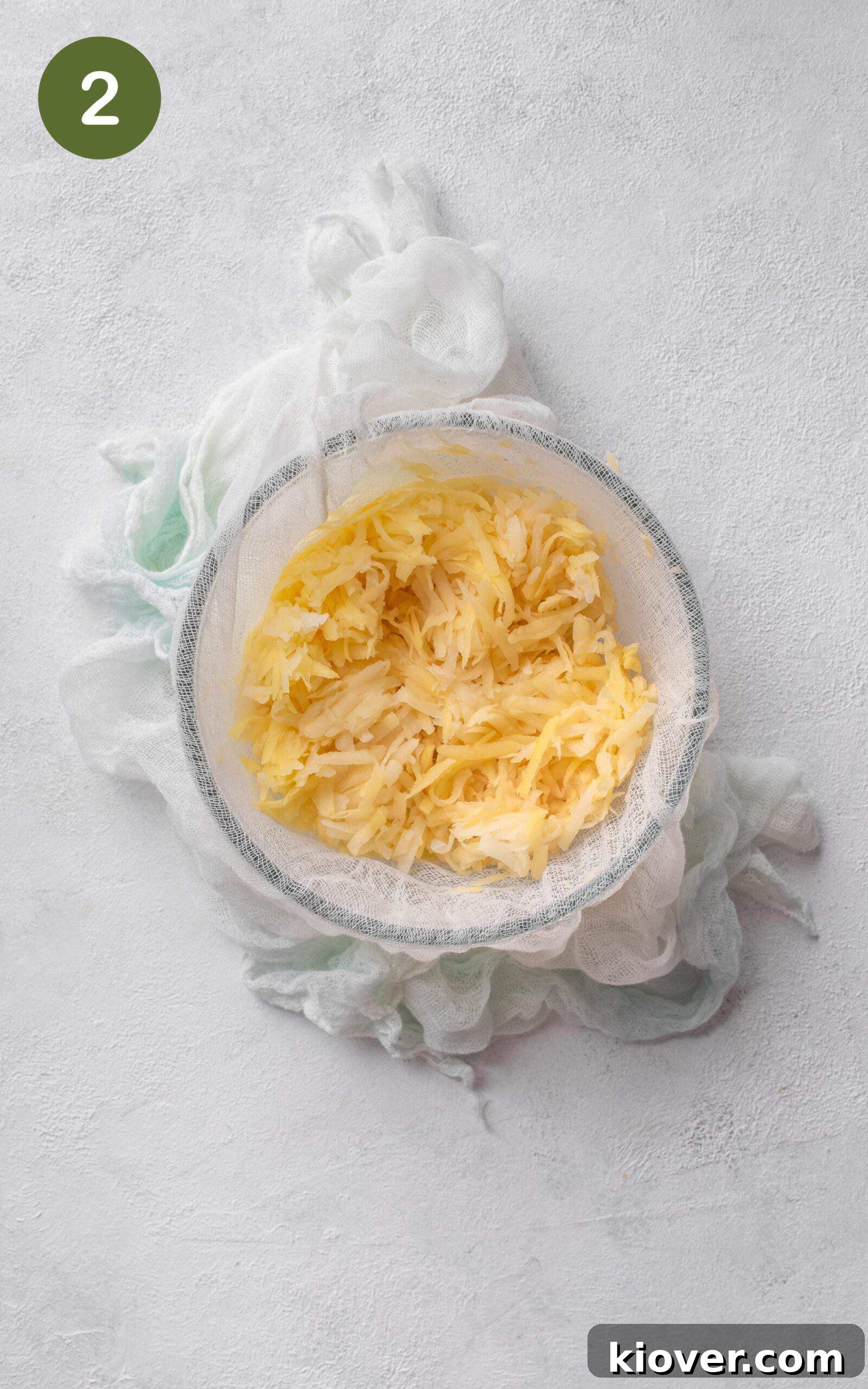 Crispy Swiss Potato Rösti Recipe — Golden Hash Brown Style 5 grated potatoes in a bowl.