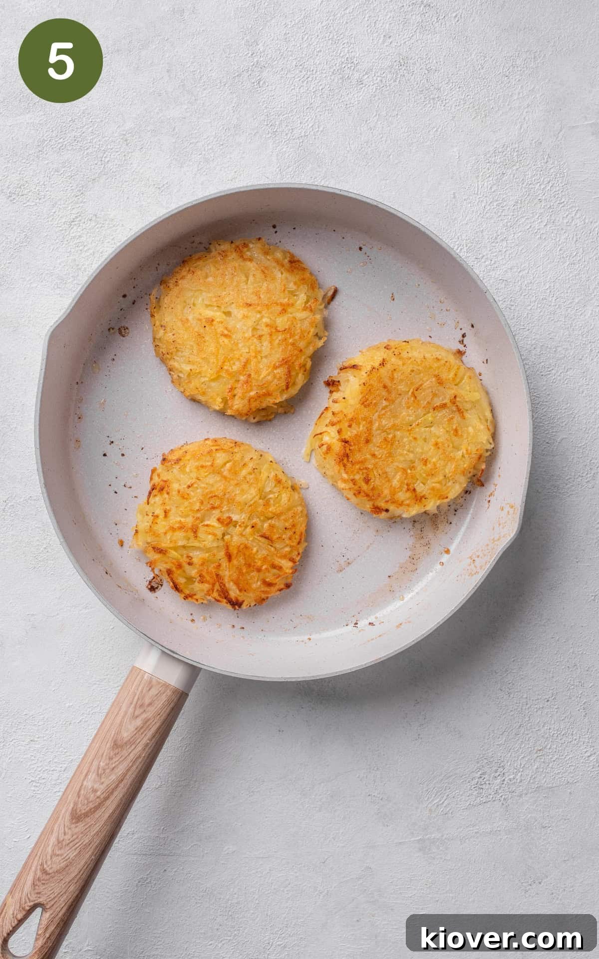 Crispy Swiss Potato Rösti Recipe — Golden Hash Brown Style 8 Cooking the rosti in the skillet with melted butter.